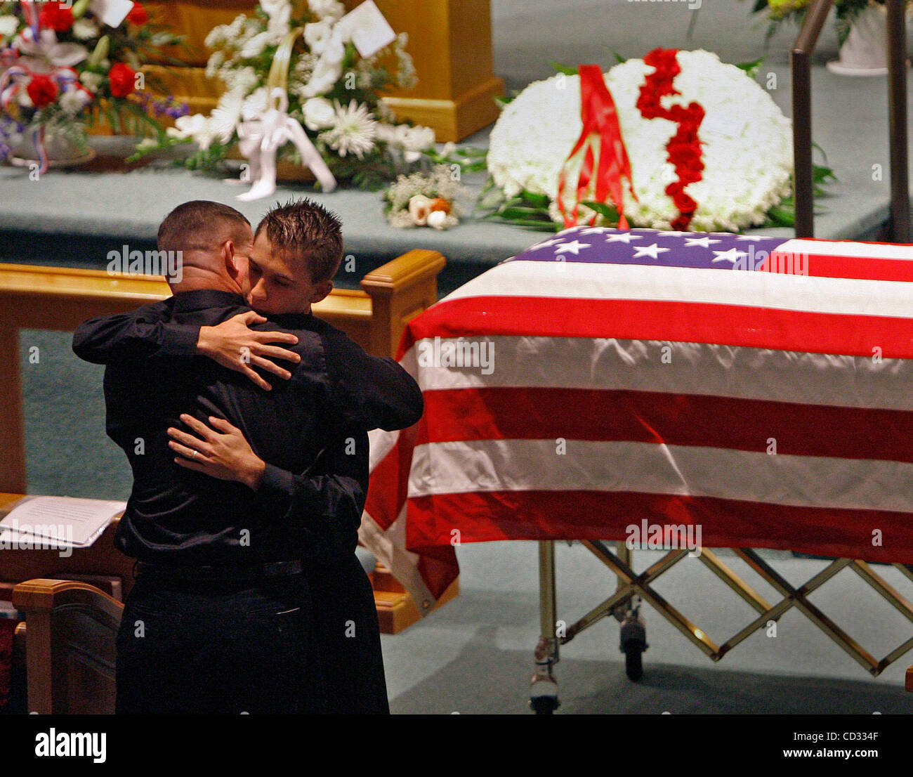CAPTION: PHOTO 3/6:  (Sunday, Hudson , 04/06/2008)  Patrick Miller Sr. (left) hugs his son Michael Miller during the funeral ceremony for his other son PFC Patrick Joseph 'PJ' Miller at the First United Methodist Church in Hudson on Sunday, 4/6/08. LANCE ARAM ROTHSTEIN  |  Times PT 286170 ROTH mille Stock Photo