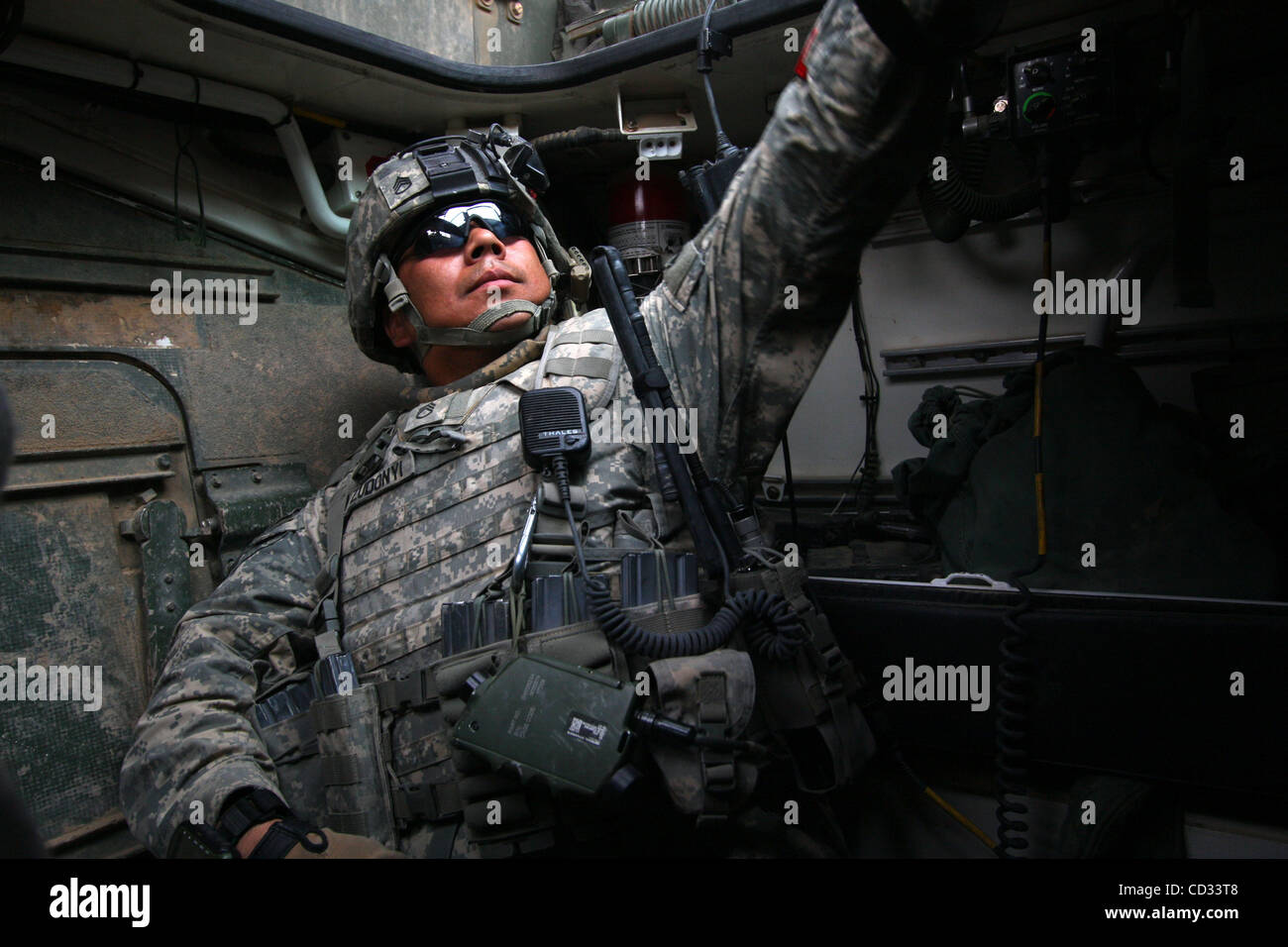 Apr 07, 2008 - Khalis, Diyala Province, Iraq - A soldier of 3rd Platoon, Cobra Troop, 2nd Squadron, 1st Cavalry Regiment as part of 4th Stryker Brigade Combat Team, 2nd Infantry Division prepares to get up to the hatch of a Stryker vehicle on the way to patrol the town of Jadidah in Diyala province, Stock Photo