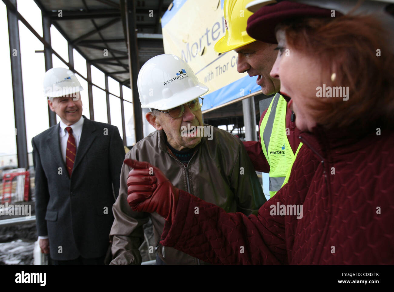 KYNDELL HARKNESS â€¢ kharkness@startribune.com Hilding Mortenson, 100, sang the University of Minnesota's fight song along with athletic director Joel Maturi, and Margaret Carlson, of the Alumni Association after Mortenson laid the first brick to the new football stadium. Mortenson was a sophomore i Stock Photo