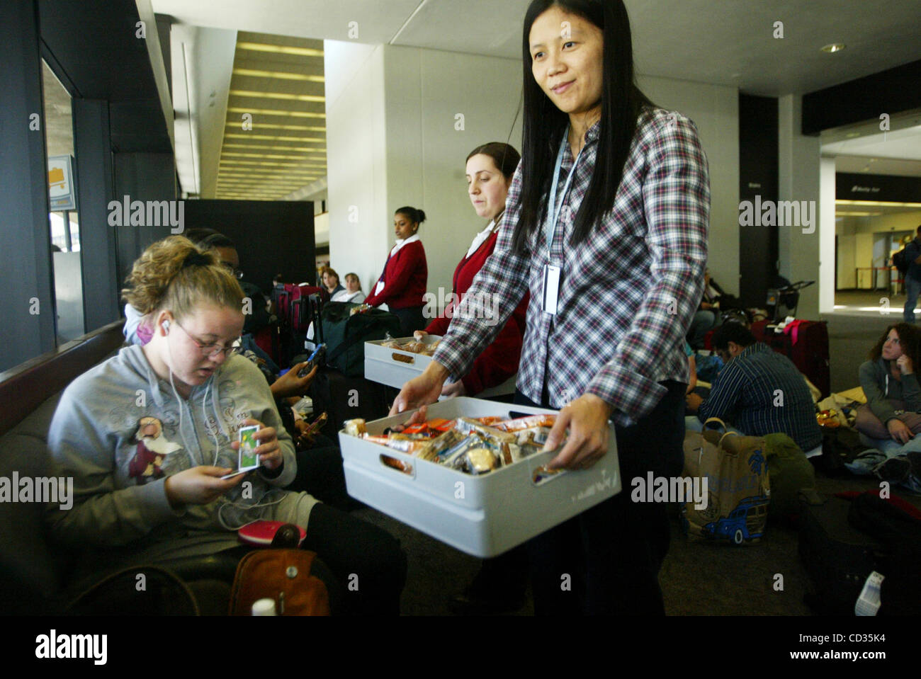 American Airlines representative Sydney Kyain offers snacks to ...