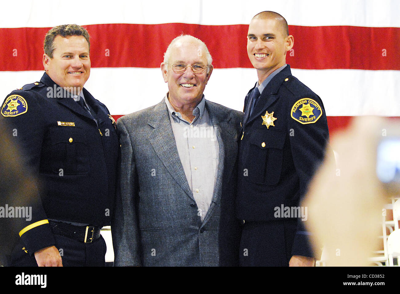 Geoffrey Ball, right, poses for a photo with his biological uncle Dean Stavert, far left, and his biological grandfather Bud Harlan after Ball is sworn in as a member of the Alameda County Sheriff's Department on Friday, April 18, 2008 in a ceremony at the Alameda County Fairgrounds in Pleasanton, C Stock Photo