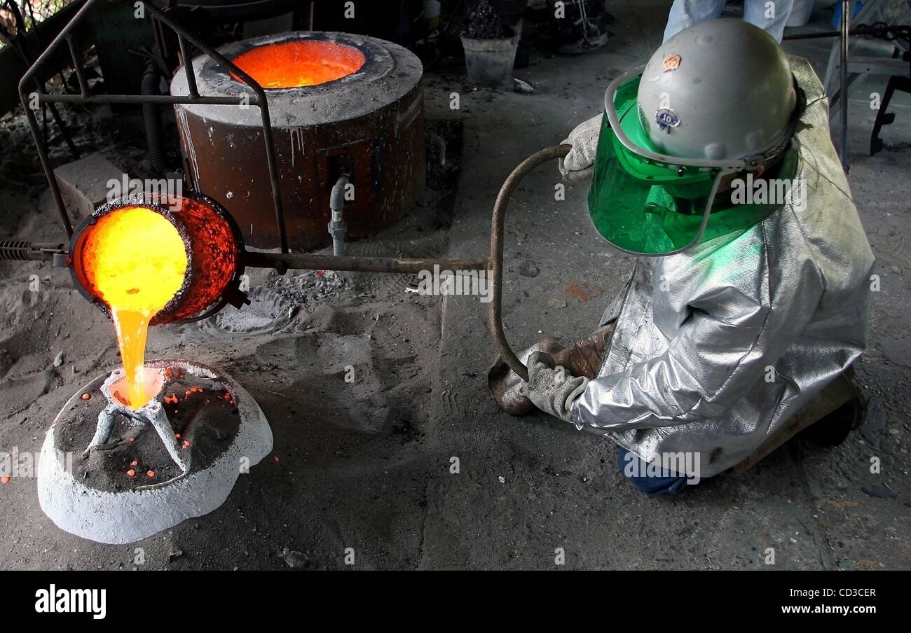 Apr 25, 2008 - St. Lucie, Florida, USA - Sculptor PAT COCHRAN, owner of Shadetree Studio in St. Lucie Village, pours molten bronze for giant fruit sculptures he was casting for a local builder. The 20 inch diameter oranges will be placed at the entryway to a new office building on Citrus Avenue in F Stock Photo