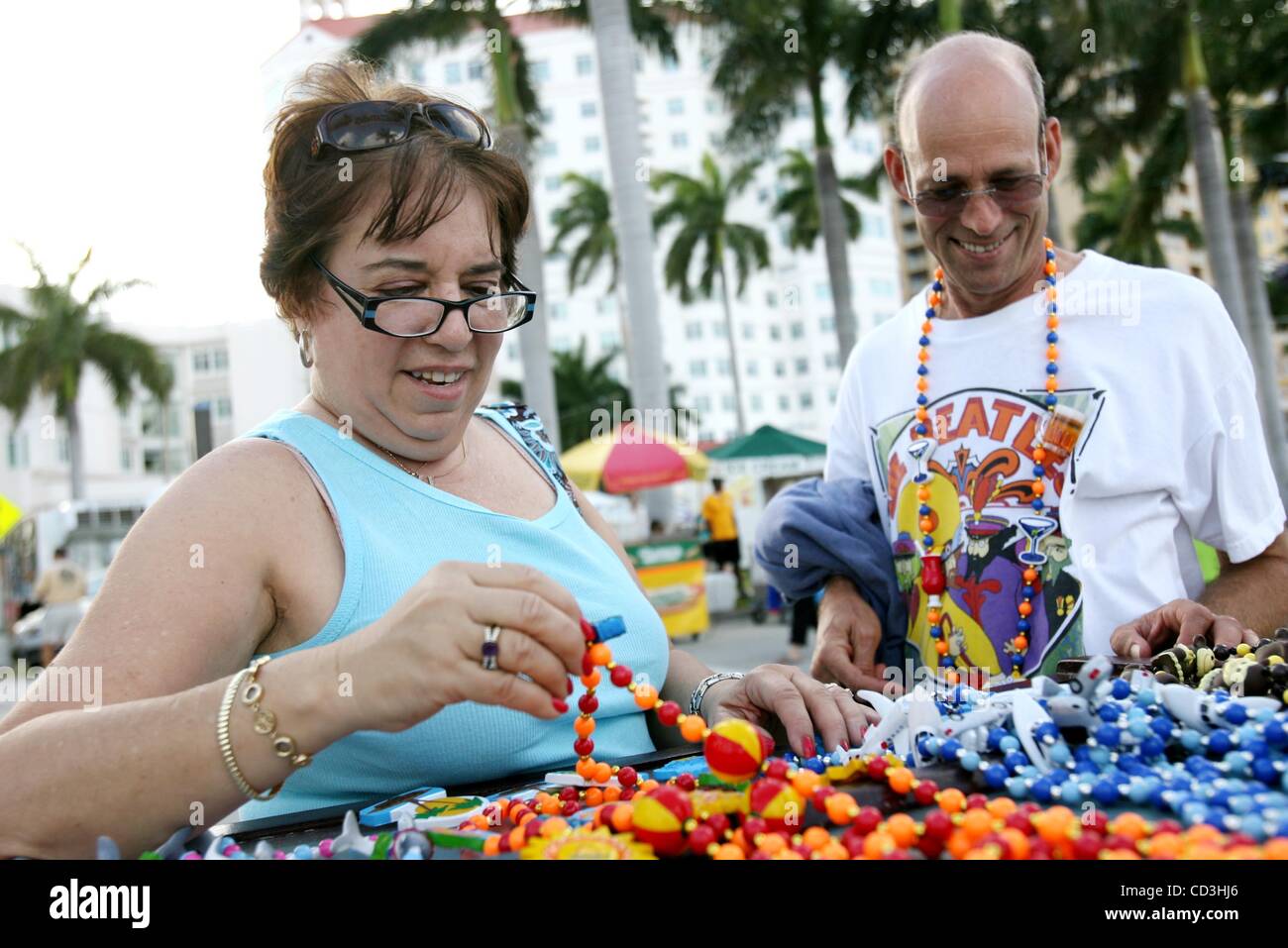 050208 met sunfest 04 Staff Photo by Gary Coronado/The Palm Beach Post 0052248B TBA -- West Palm Beach--Nancy, left, and Bruce Eige, of Boca Raton, buy some beads at SunFest in West Palm Beach Friday. Stock Photo
