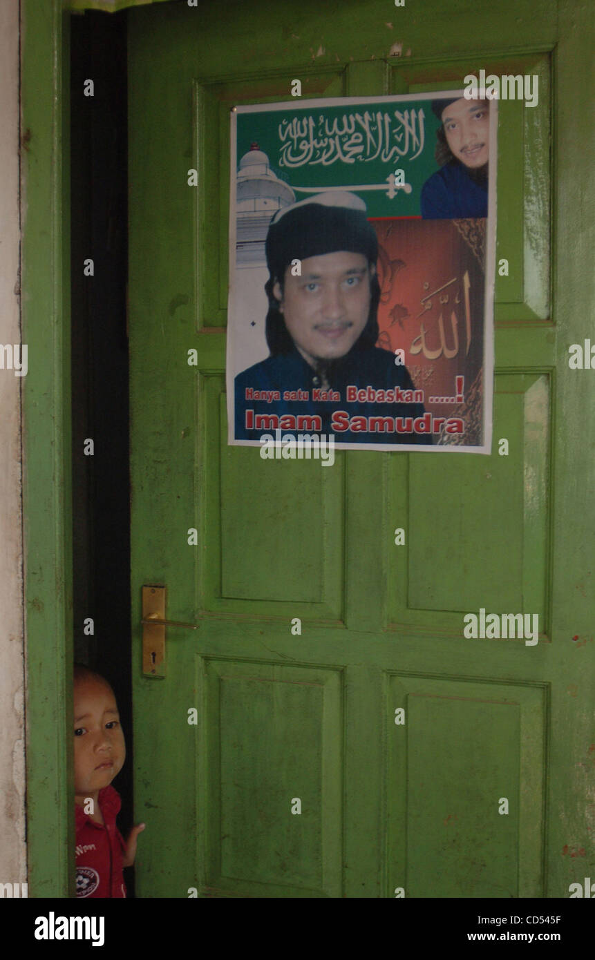 Mubin,a nephew of Bali bomber Imam Samudra, stands near the bomber's portrait which reads, 'Only one word releases Imam Samudra' in his mother's home in Serang, Banten province, Indonesia, Nov 5, 2008. Three Indonesian militants on death row for the 2002 Bali bombings have exhausted legal options an Stock Photo