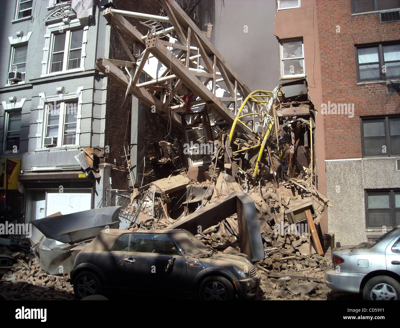 firefighters work amid the rubble of a building after a crane collapsed ...