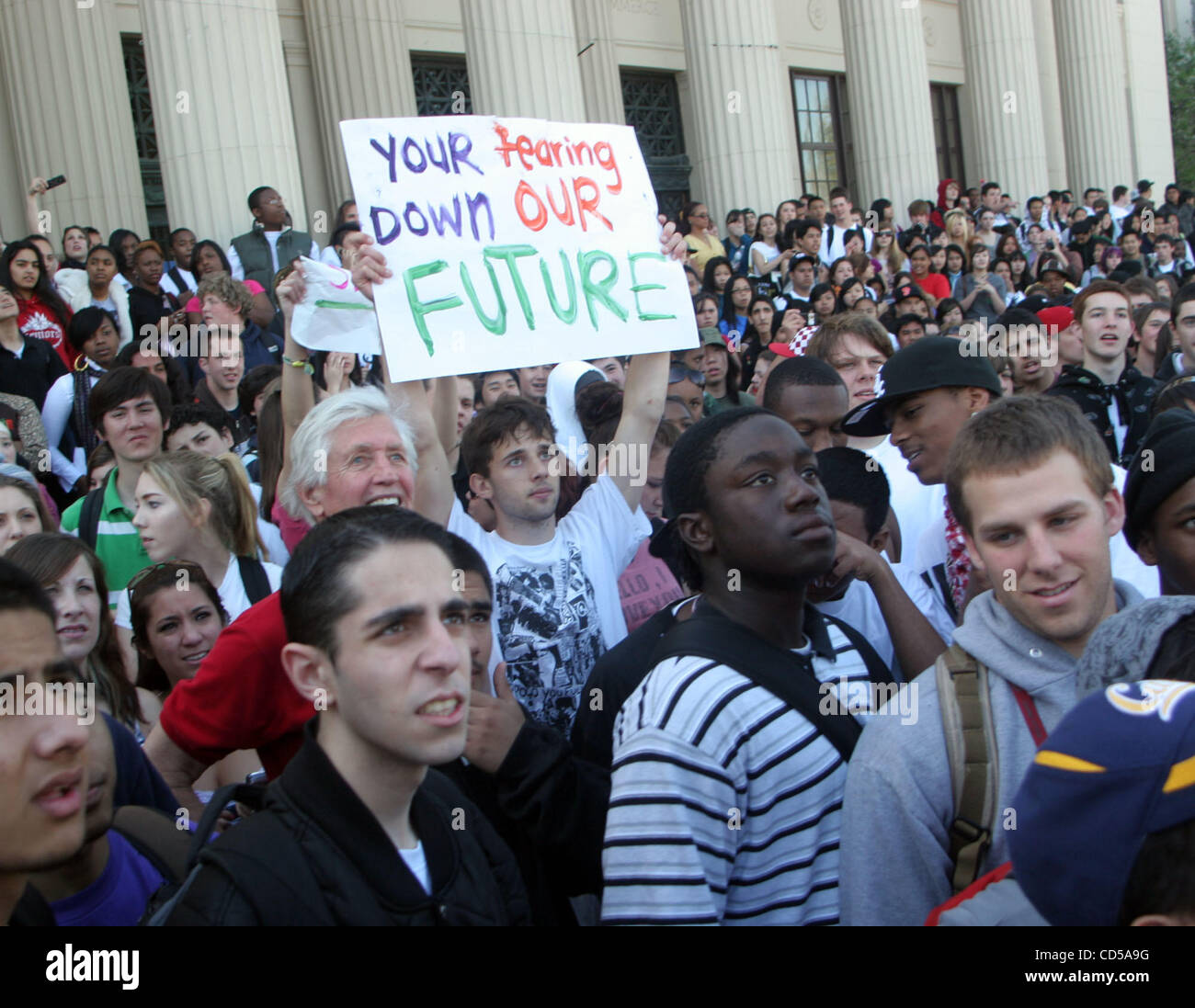 Hundreds of students protest proposed cuts in athletics and music