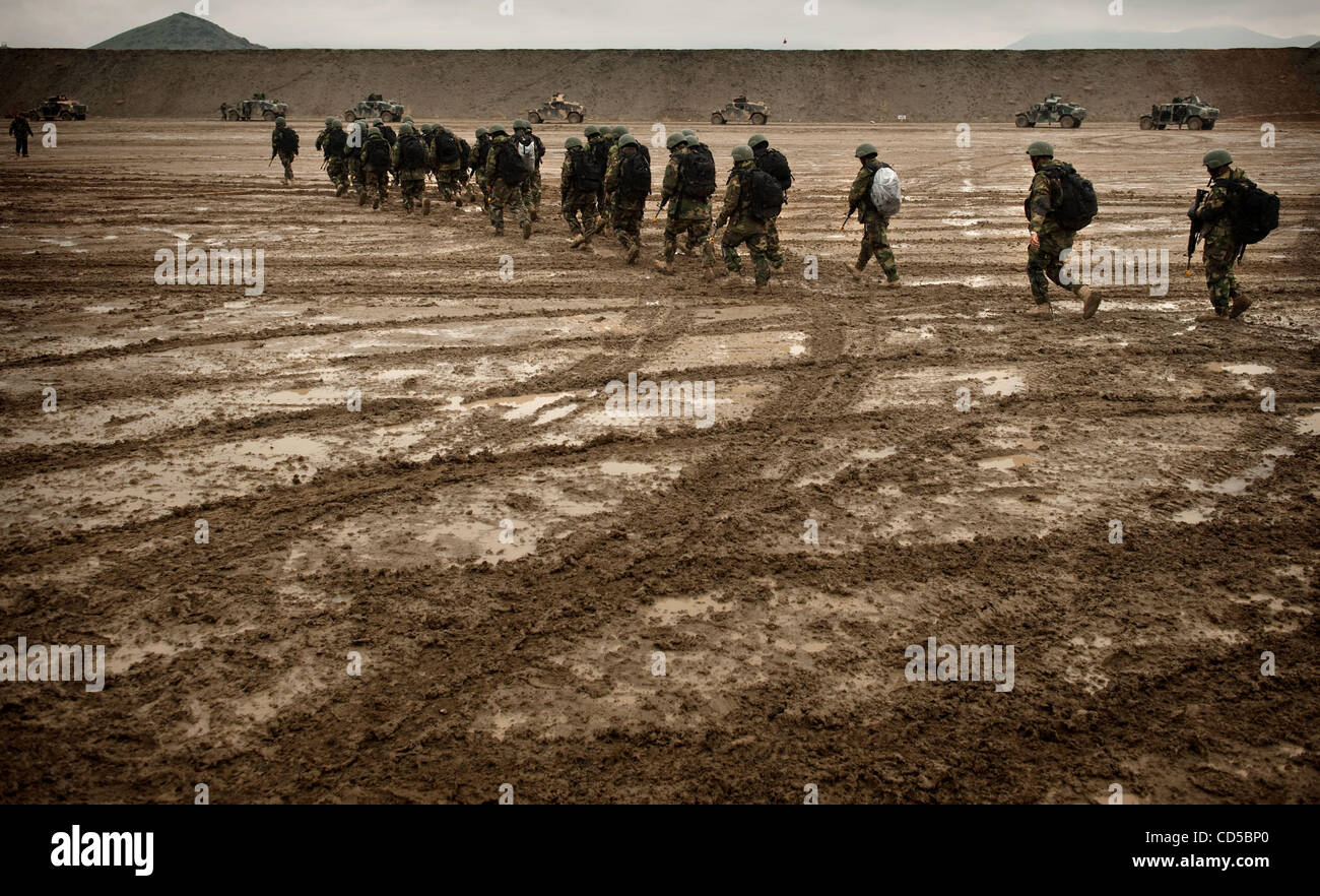 Apr 09, 2008 - Camp Morehead, Afghanistan - Afghan Commandos march across a muddy field to get to their Humvees for convoy training under the supervision of U.S. Army Special Forces soldiers. Created two years ago by the US Special Forces, the commandos have risen from the Afghan National Army's eli Stock Photo