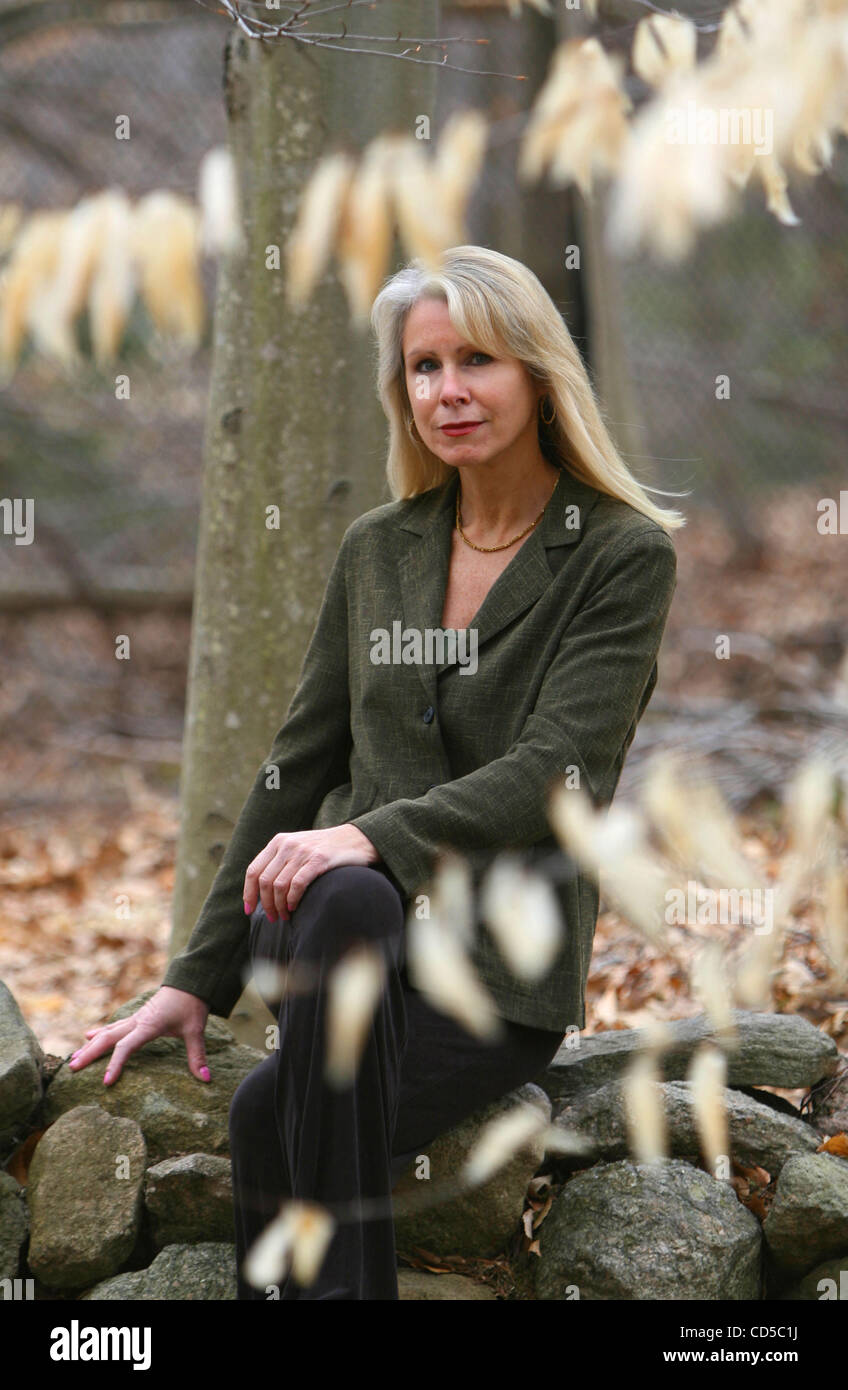 BONNIE MCENEANEY, author of "Messages: Signs, Visits and Premonitions from Loved Ones Lost on 9/11"  at her home in New Canaan, Connecticut. She sits on a stone wall built by her late husband Eamon, who worked at Cantor Fitzgerald on the 105th floor of the North Tower and died in the attacks on the  Stock Photo