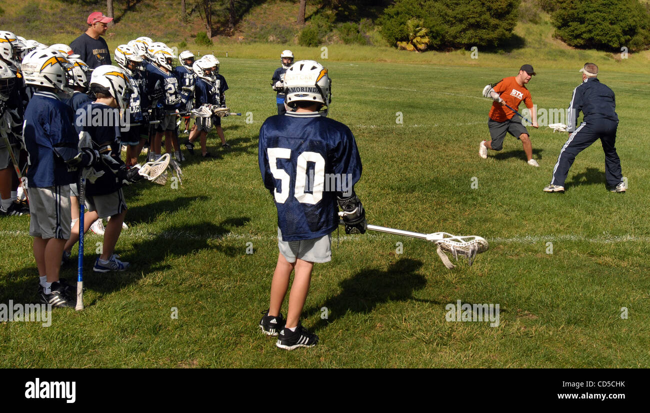 Jeff Zywicki, who currently leads the National Lacrosse League in scoring (in shorts and orange shirt) and Mike Huguet, coach of the Lamorinda Burns square off to teach the basics of Lacrosse at Rheem Elementary School on Monday April 14, 2008  in Moraga, Calif. (Susan Tripp Pollard/Contra Costa Tim Stock Photo