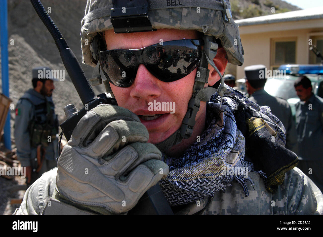 Apr 29, 2008 - Paktya Province, Afghanistan - LIEUTENANT KEVIN BELL of the 1-61 Cavalry, 4th Brigade Combat Team, 101st Airborne, keeps in radio contact with his platoon securing the exterior of the Afghan police station while meeting the new Afghan National Civil Order Police (ANCOP) district comma Stock Photo