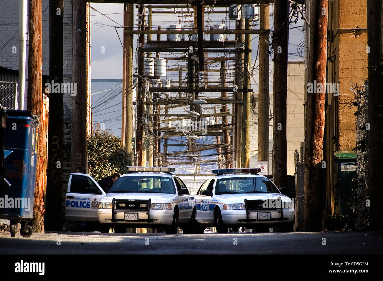Jun 12, 2008 - Vancouver, British Columbia, Canada - Squad cars on an alleyway drug raid. The Vancouver Police Department has a high-profile branch half a block from the dangerous crossroads of Hastings and Main. The Downtown Eastside has always been the center of Vancouver's hard drug trade. In fac Stock Photo