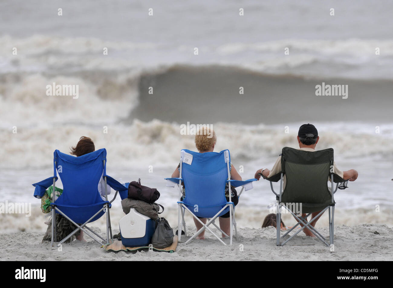 Aug 22 08 New Smyrna Beach Florida Usa Tourists Sit And Watch The Waves Produced By Aug 22 08 New Smyrna Beach Florida Usa Tourists Sit And Watch The Waves Produced By