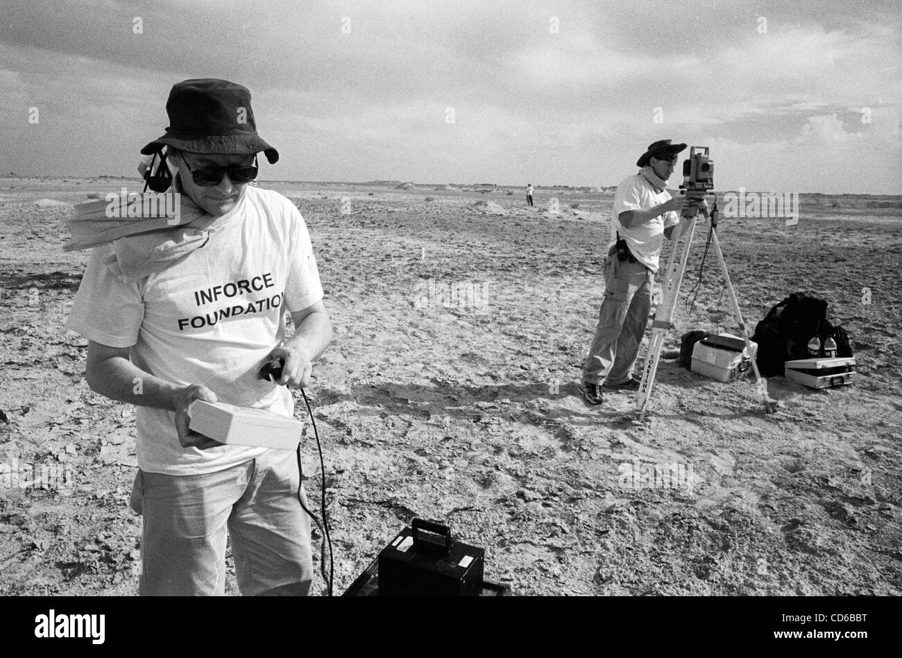 May 24, 2003 - Al-Musayab, Iraq - Members of Inforce, a UK team of 'grave hunters,' set up the GPS/laser surveying system, preparing to  scan the soil for disturbance to check for the presence of a mass grave, near Al-Musayab, Iraq. This was the first time the ensemble of high-tech geological tools  Stock Photo