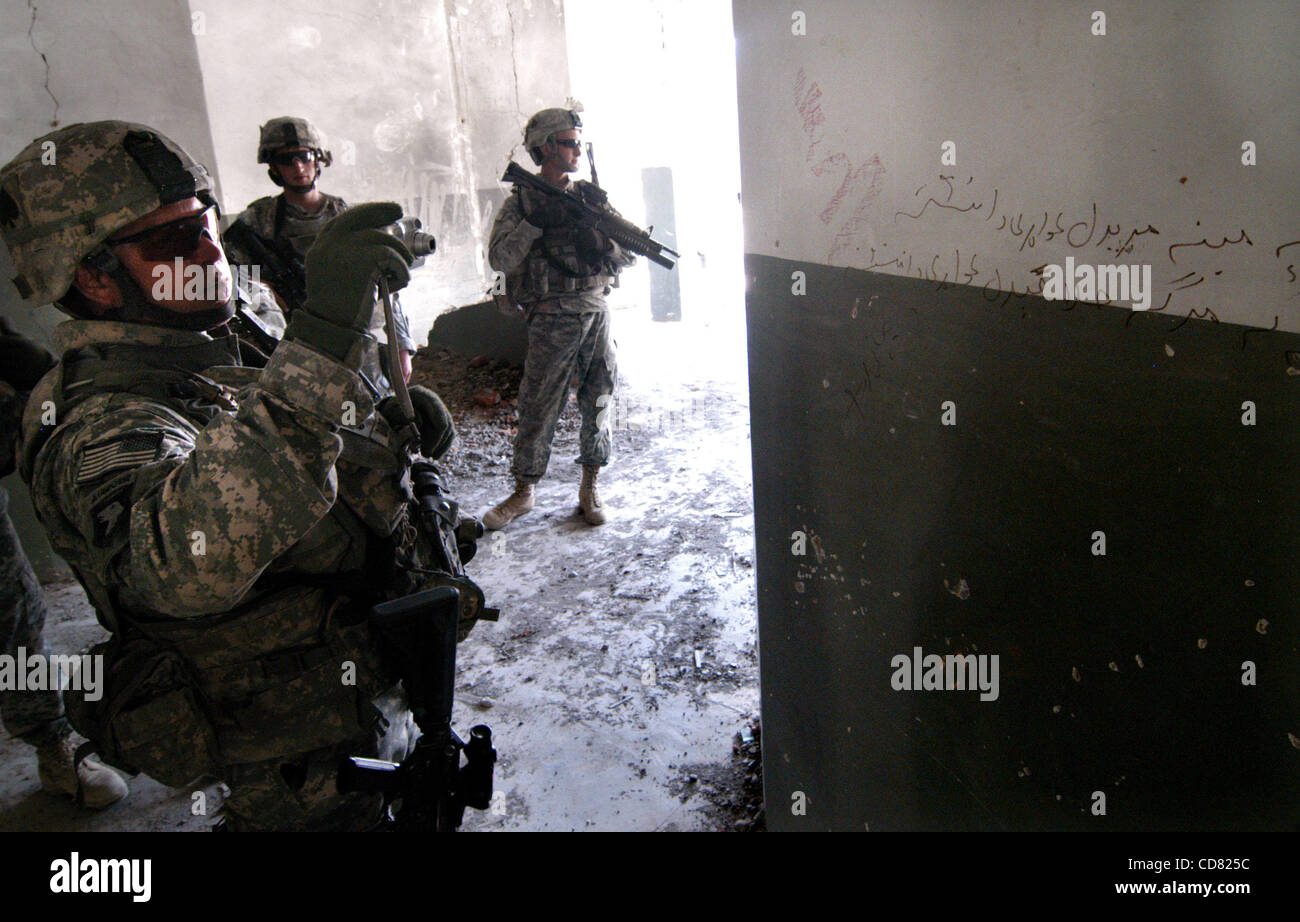 Apr 05, 2008 - Paktya, Afghanistan - During a routine patrol in eastern Afghanistan, Sergeant First Class ANTHONY BARNES takes a snapshot of writing on the wall of a school his platoon came across that had been gutted last year by the Taliban. The writing, translated from the Pashtu, is a warning me Stock Photo