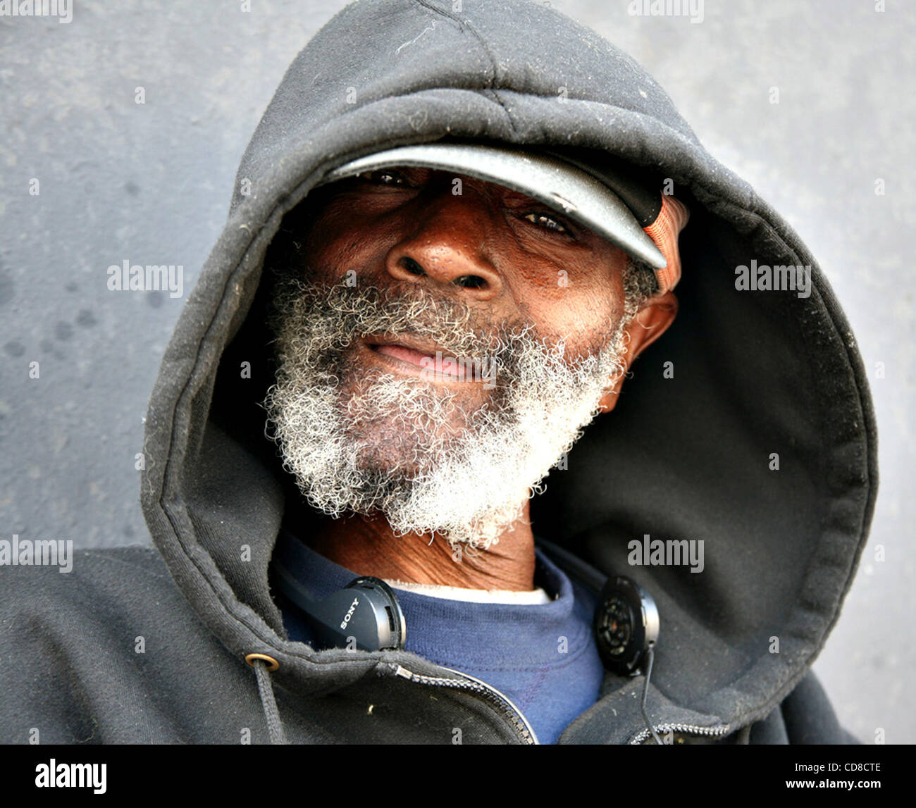 Oct 19, 2008 - Los Angeles, California, U.S. - Homeless man with hat and hood. According to the Institute for the Study of Homelessness and Poverty at the Weingart Center, an estimated 254,000 men, women and children experience homelessness in Los Angeles County during some part of the year and appr Stock Photo