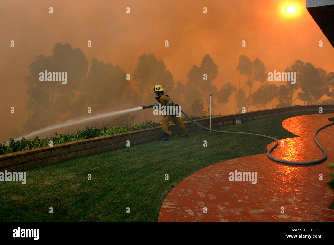 Nov 15, 2008 - Los Angeles, California, USA - A firefighter douses ...