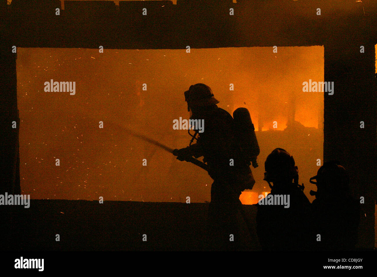 Nov 15, 2008 - Los Angeles, California, USA - A firefighter works on a house burning in the Sayre Fire in the Sylmar  section of Los Angeles. The fire originated in Sylmar and jumped two freeways as it burned west into Granada Hills pushed by stron Santa Ana winds. Credit Image: © Jonathan Alcorn/ZU Stock Photo