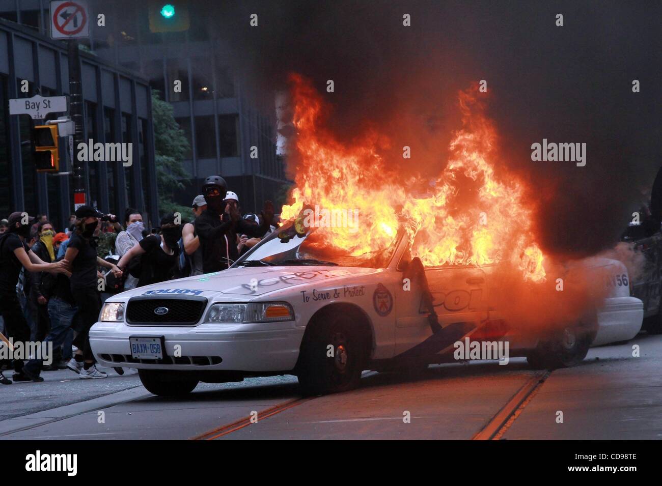 Jun 26, 2010 - Toronto, Ontario, Canada - Cop cars are smashed and set on fire as rioters take over the downtown. Chaos erupted downtown due to the G8 and G20 summits. The G20 Summit is being held from June 26-27. Protesters flocked to the streets and police presence increased over the weekend. (Cre Stock Photo