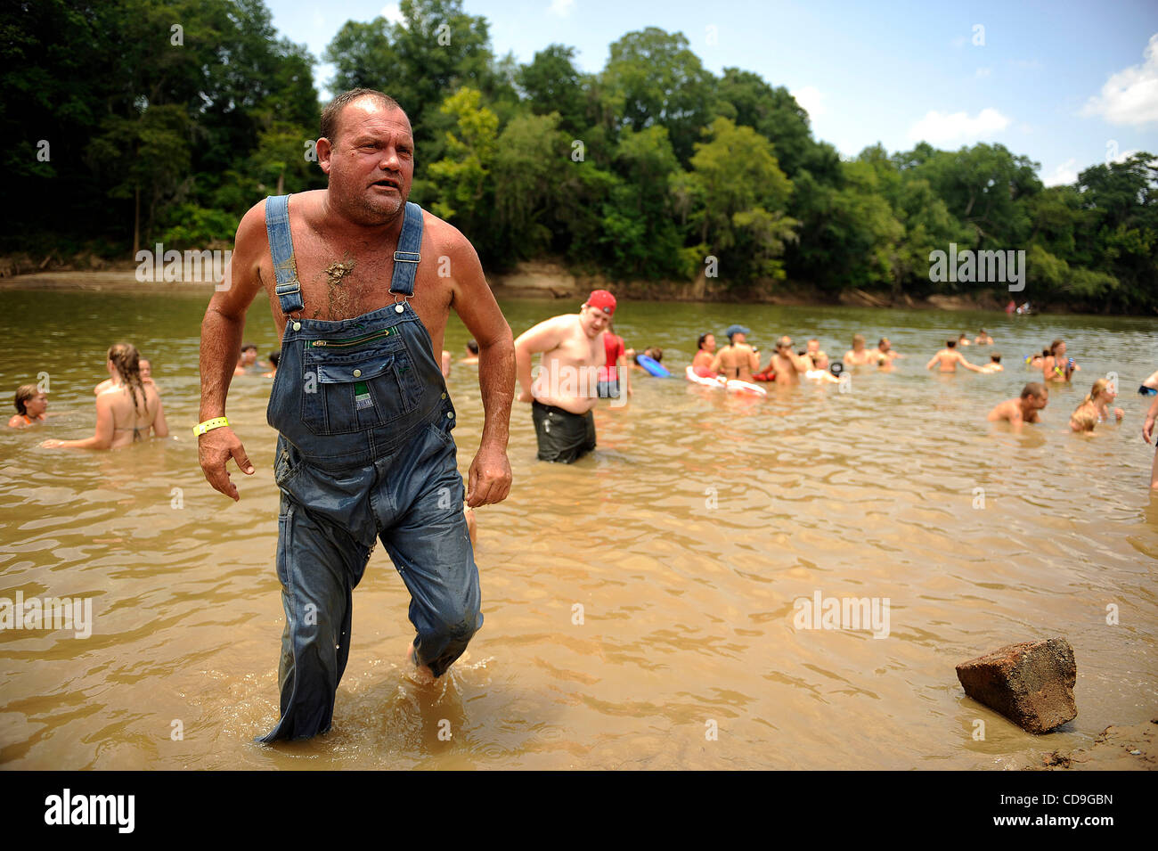 SATURDAY JULY 10, 2010 EAST DUBLIN, GEORGIA -A drunk Redneck Games participant  exits the river at Buckeye Park during the Redneck Games in East Dublin, Georgia. The games started in 1996 as spoof on the Olympics which were being held in Atlanta, Georgia at the time. participants compete in events l Stock Photo