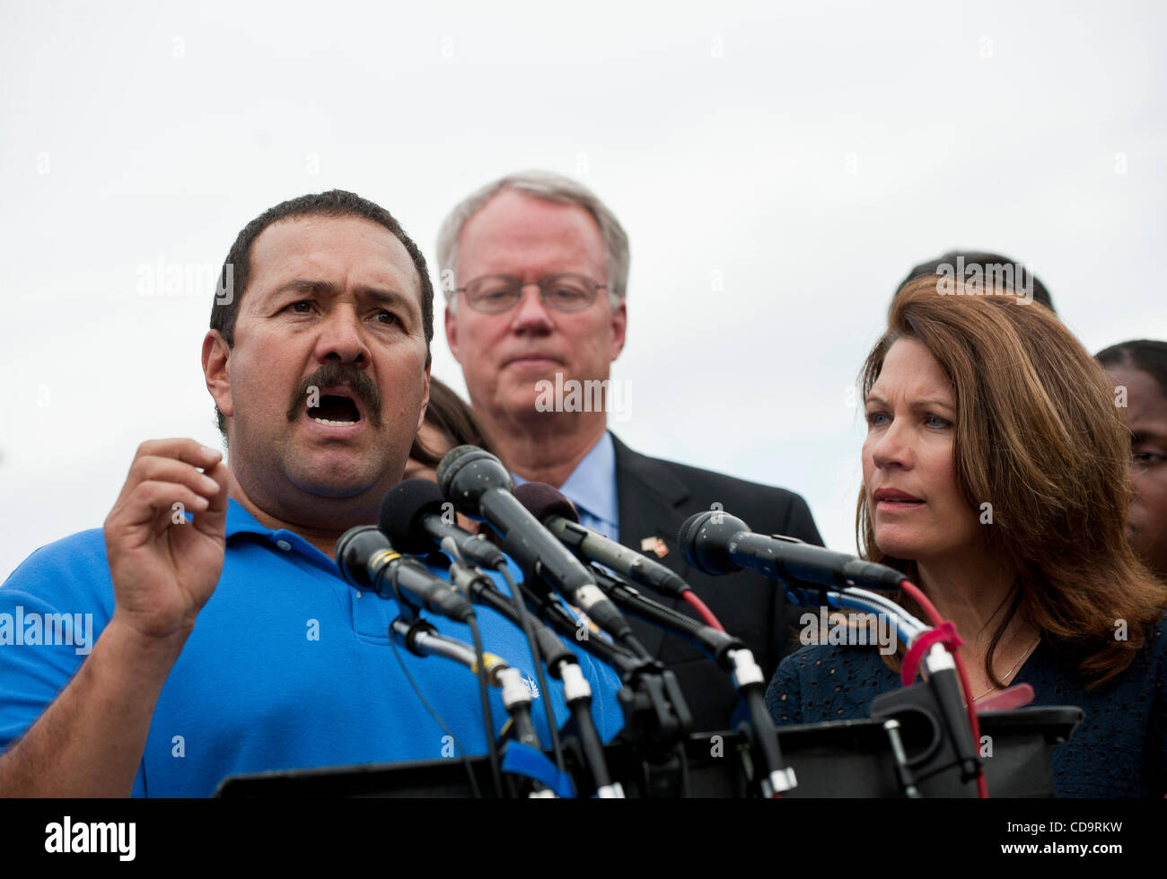 Jul 21, 2010 - Washington, District of Columbia, U.S., - Rep. MICHELE BACHMANN (R-MN) looks on as TITO MUNOZ, a contruction worker from Woodbridge, Virginia, speaks to the media after the first meeting of the newly formed Tea Party Caucus outside of the Capitol on Wednesday. MICHELLE BACKMANN (right Stock Photo