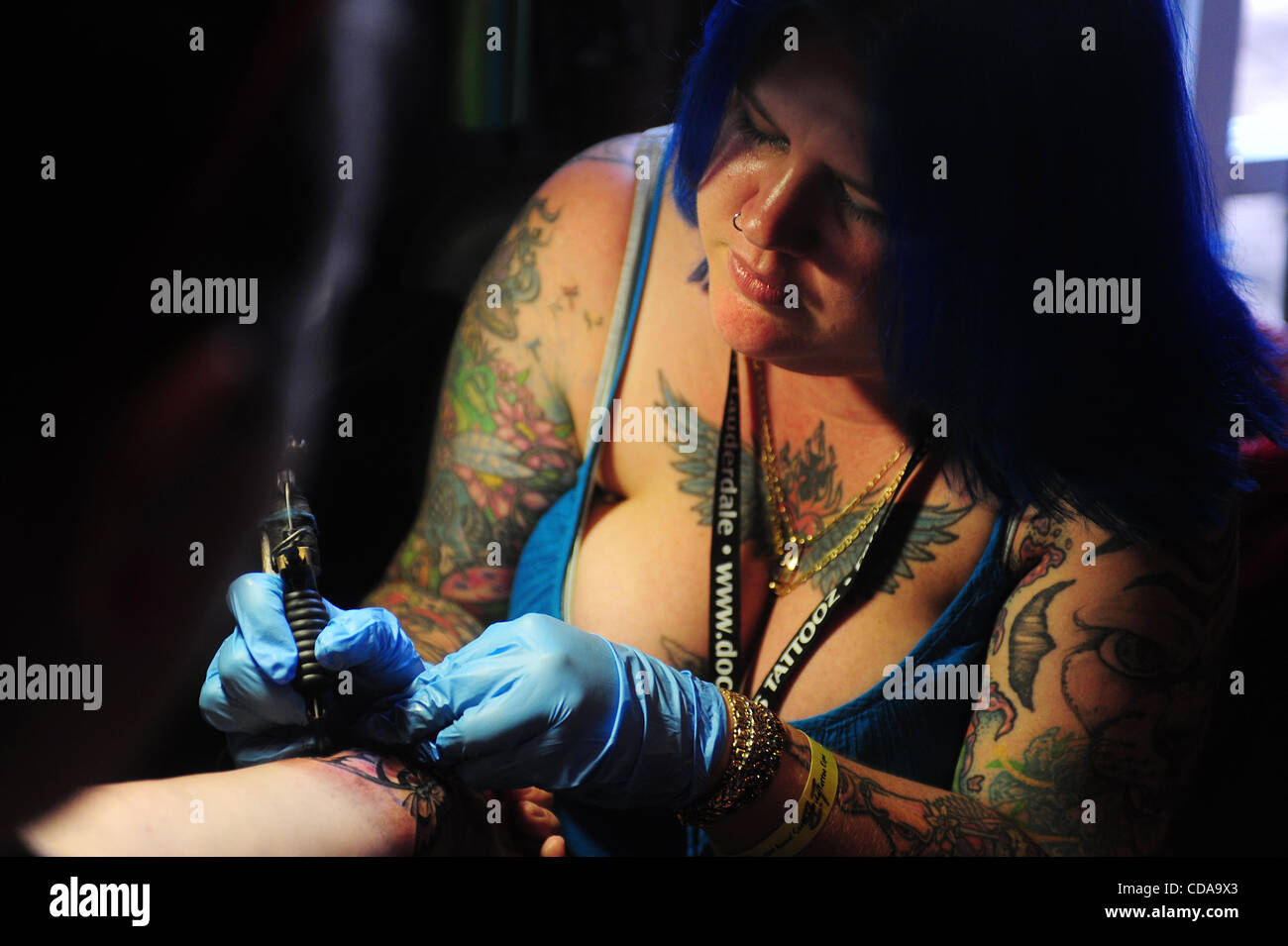 Aug. 15, 2010 - Deerfield Beach, FL - Florida, USA - United States - (CAV) TATTOO 0815D.CAV Heather Stephens of  Doc's Tattooz of Ft. Lauderdale tattoos an butterly on the wrist of Katie Brost of Ft. Lauderdale,  during the 15th Annual South Florida Tattoo Expo, Sunday, Aug. 15, at the Hilton in Dee Stock Photo