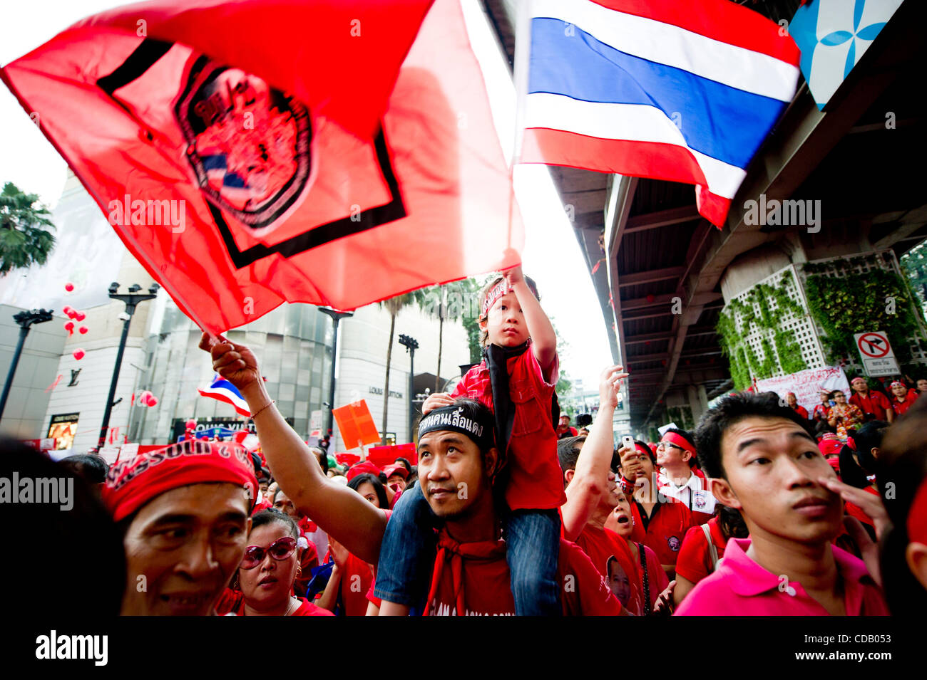 Sept. 19, 2010 - Bangkok, Thailand - Members of Red Shirt, also known as United Front for Democracy against Dictatorship (UDD), wave flags and chant slogan during the coup anniversary at Ratchaprasong intersection in downtown Bangkok. September 19 marks four years since the coup that ousted Thailand Stock Photo