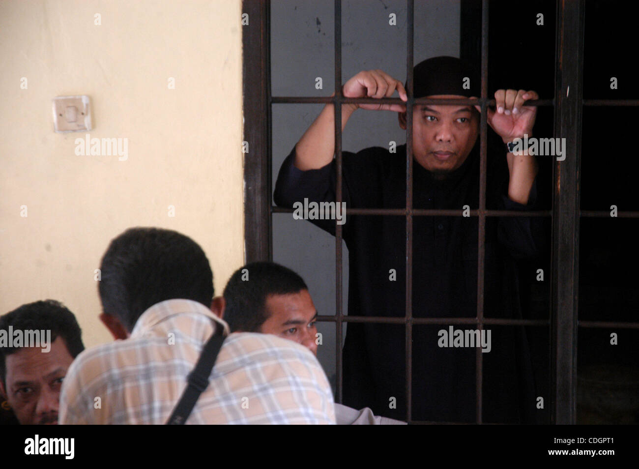 Mohammed Sofyan Tsauri, an Indonesian police officer who quit the force to become a terrorist, listens as judges read their verdict at Depok-West Java court, January 19, 2011. The court sentenced Tsauri, who was affiliated to Al-Qaeda and had trained about 170 militants to wage jihad (holy war), to  Stock Photo
