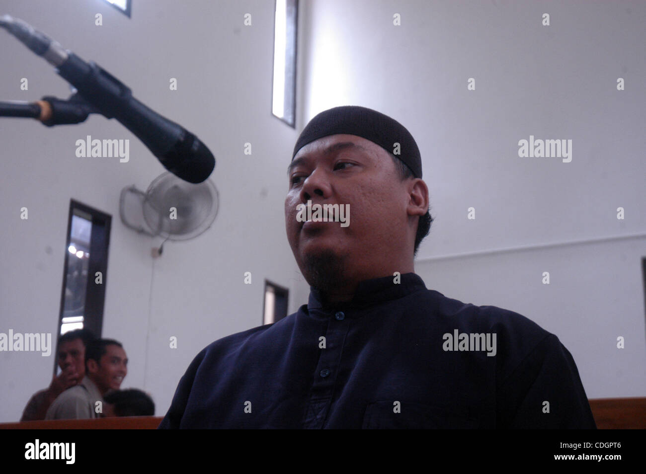 Mohammed Sofyan Tsauri, an Indonesian police officer who quit the force to become a terrorist, listens as judges read their verdict at Depok-West Java court, January 19, 2011. The court sentenced Tsauri, who was affiliated to Al-Qaeda and had trained about 170 militants to wage jihad (holy war), to  Stock Photo