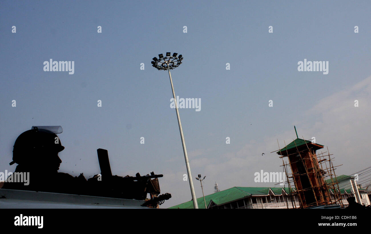 A indian  policeman stands guard in front of Kashmir's clock tower at historic Lal Chowk (Red Square) area ahead of planned national flag hoisting by India's main opposition Bharatiya Janata Party (BJP) at the tower on Republic Day, in Srinagar,the summer capital of indian kashmir  January 25, 2011. Stock Photo