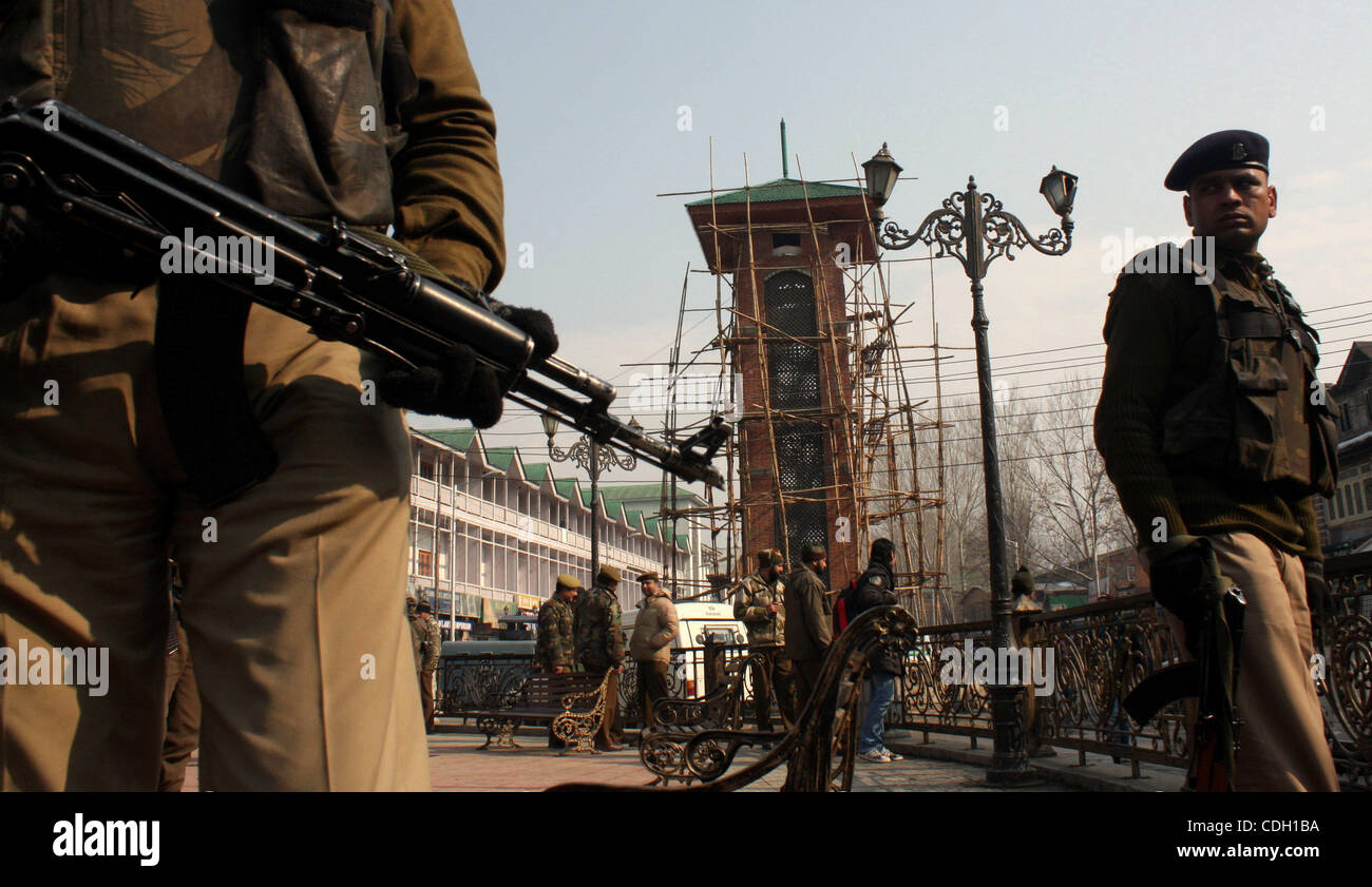 Jan. 25, 2011 - Srinagar, Kashmir, India - An Indian policeman stands guard in front of Kashmir's clock tower at historic Lal Chowk (Red Square). Security has been tightened near and around the clock tower as BJP is planning to hoist an Indian national flag at the clock tower on Republic Day celebra Stock Photo