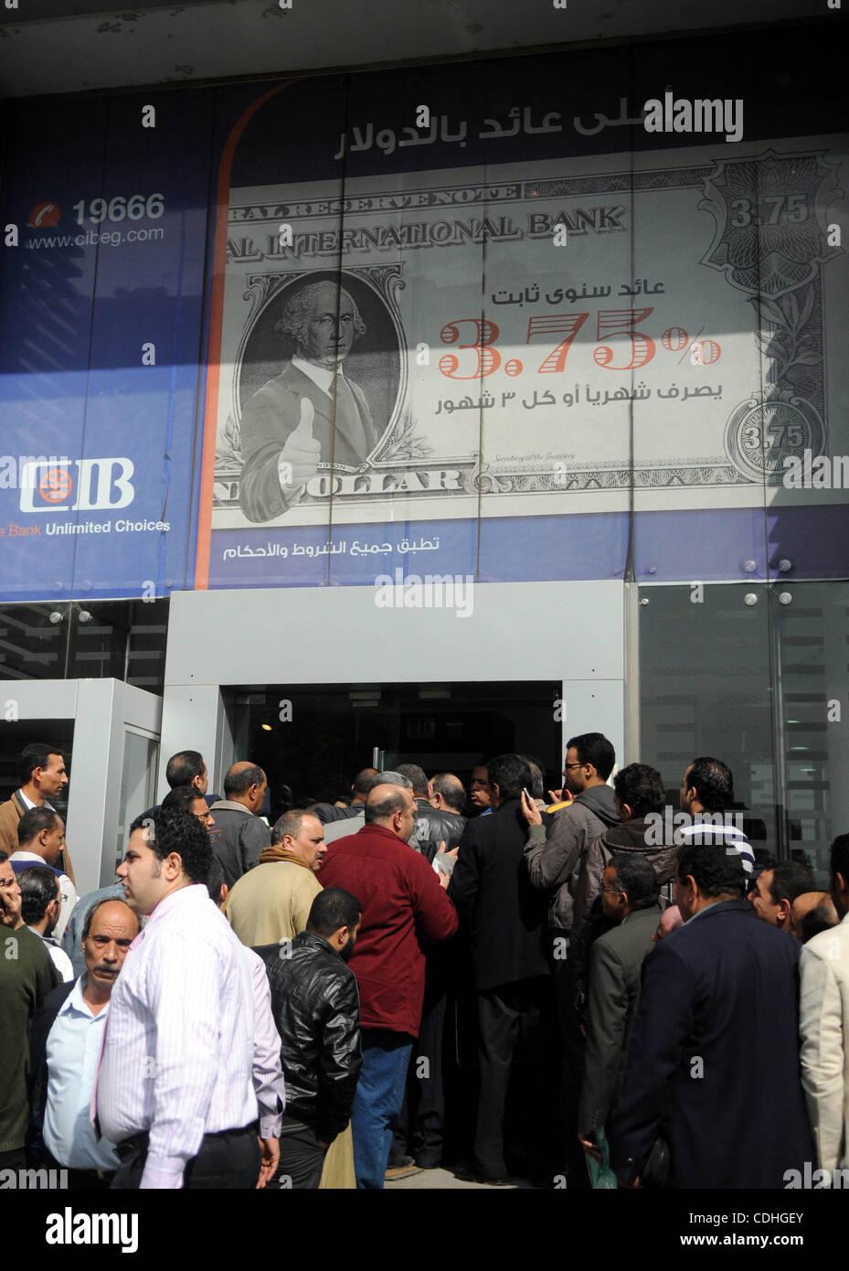 Customers queue at Egypt banks in Cairo February 6, 2011. Egypt banks to allow transfers, limit cash withdrawals . Egypt's banks open today for the first time in more than a week amid investor concern that a possible run on deposits may weaken the currency and raise government borrowing costs.  Phot Stock Photo