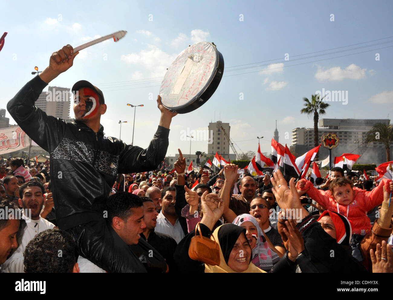 Egyptians celebrate and wave national flags in Tahrir Square in Cairo, Egypt, Saturday, Feb. 12, 2011. Egypt exploded with joy, tears, and relief after pro-democracy protesters brought down President Hosni Mubarak with a momentous march on his palaces and state TV. Mubarak, who until the end seemed  Stock Photo