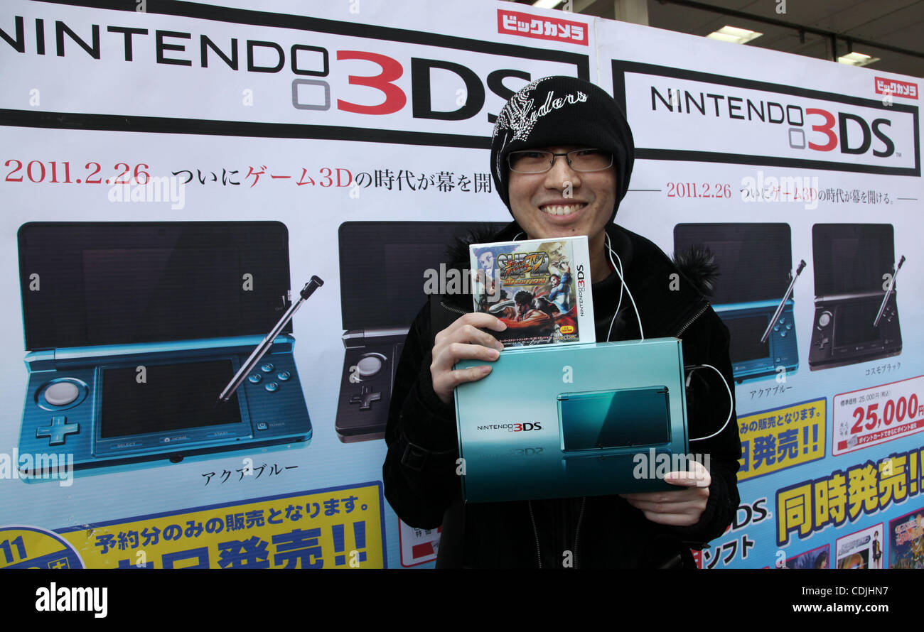 Feb. 26, 2011 - Tokyo, Japan - Customer holds his 'Nintendo 3DS' at an  electronics retail store in Tokyo, Japan. Nintendo 3DS allows users to see  its screen 3-D without wearing special