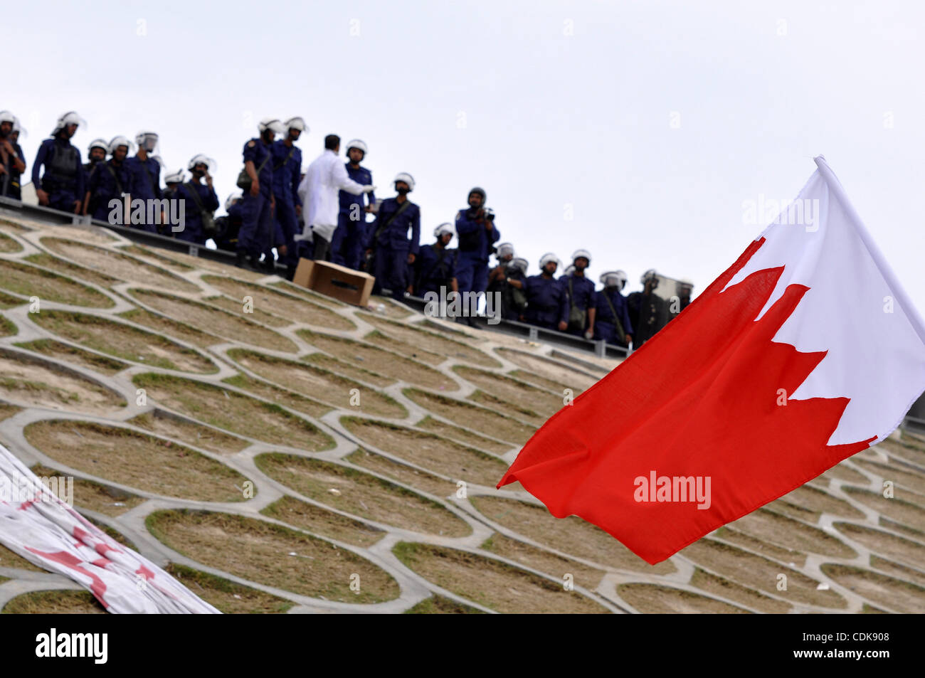 Bahraini anti-government protesters demonstrate in front of riot police ...
