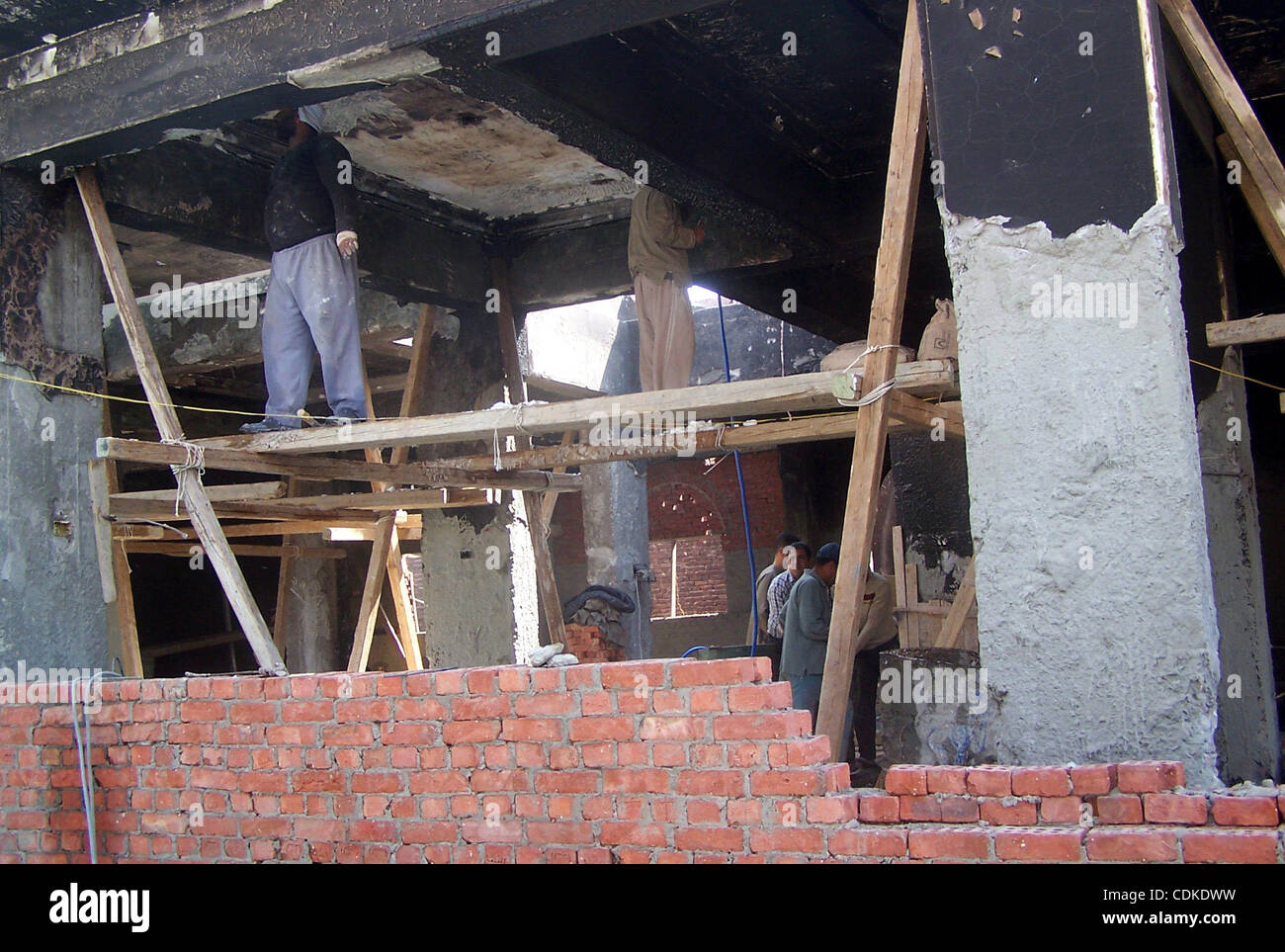 Egyptian workers take part in the rebuilding of a church in the village of Soul, south of Cairo, Egypt, Thuresday, March 17, 2011. The Egyptian army started the rebuilding of a church in Soul that was torched by a Muslim mob amid escalating tensions over a love affair between a Muslim woman and a Ch Stock Photo