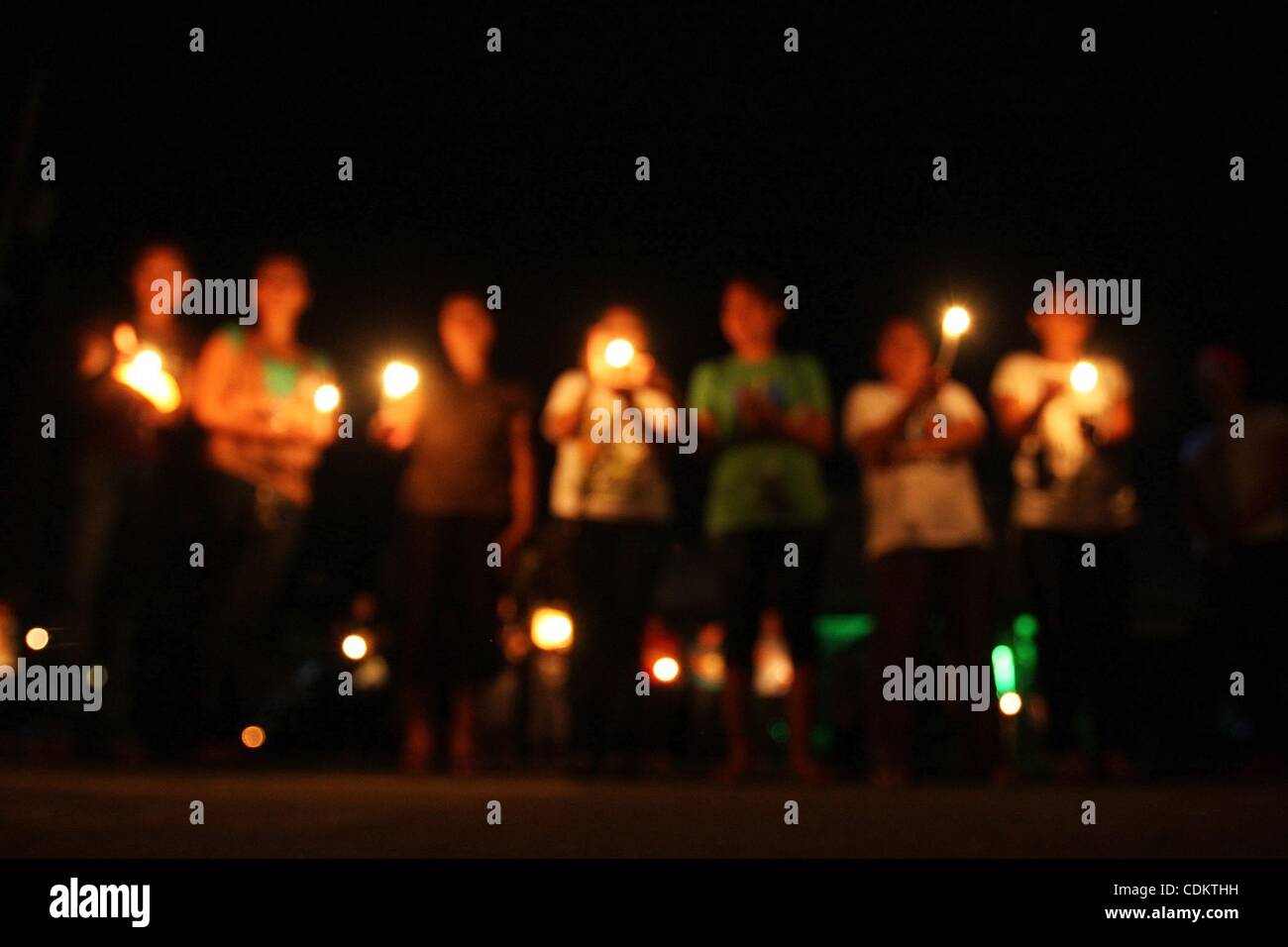 Mar 26, 2011 - Koronadal, Philippines - Environmentalists in the southern Philippine city of Koronadal on Mindanao island light candles on the streets as they join the World in turning off lights for one hour for Earth Hour on Saturday night. Earth hour, a global initiative powered by World wildlife Stock Photo