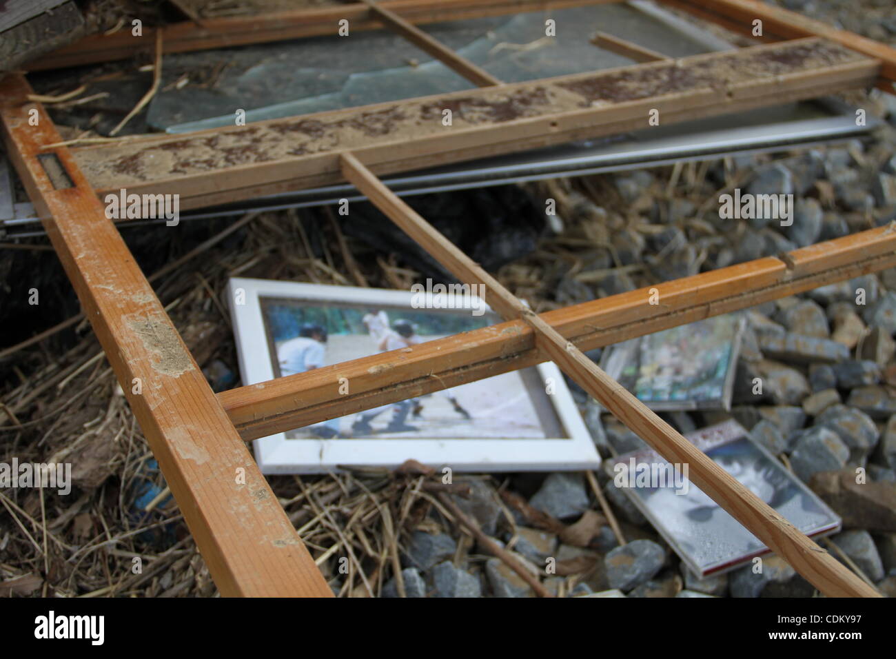 March, 28, 2011 - Kesennuma, Miyagi, Japan - Two weeks after the tsunami, this port town struggles to recover.  Family photos and old CDs washed into the rail bed. (Credit &#169; Wesley Cheek/ZUMAPRESS.com) Stock Photo