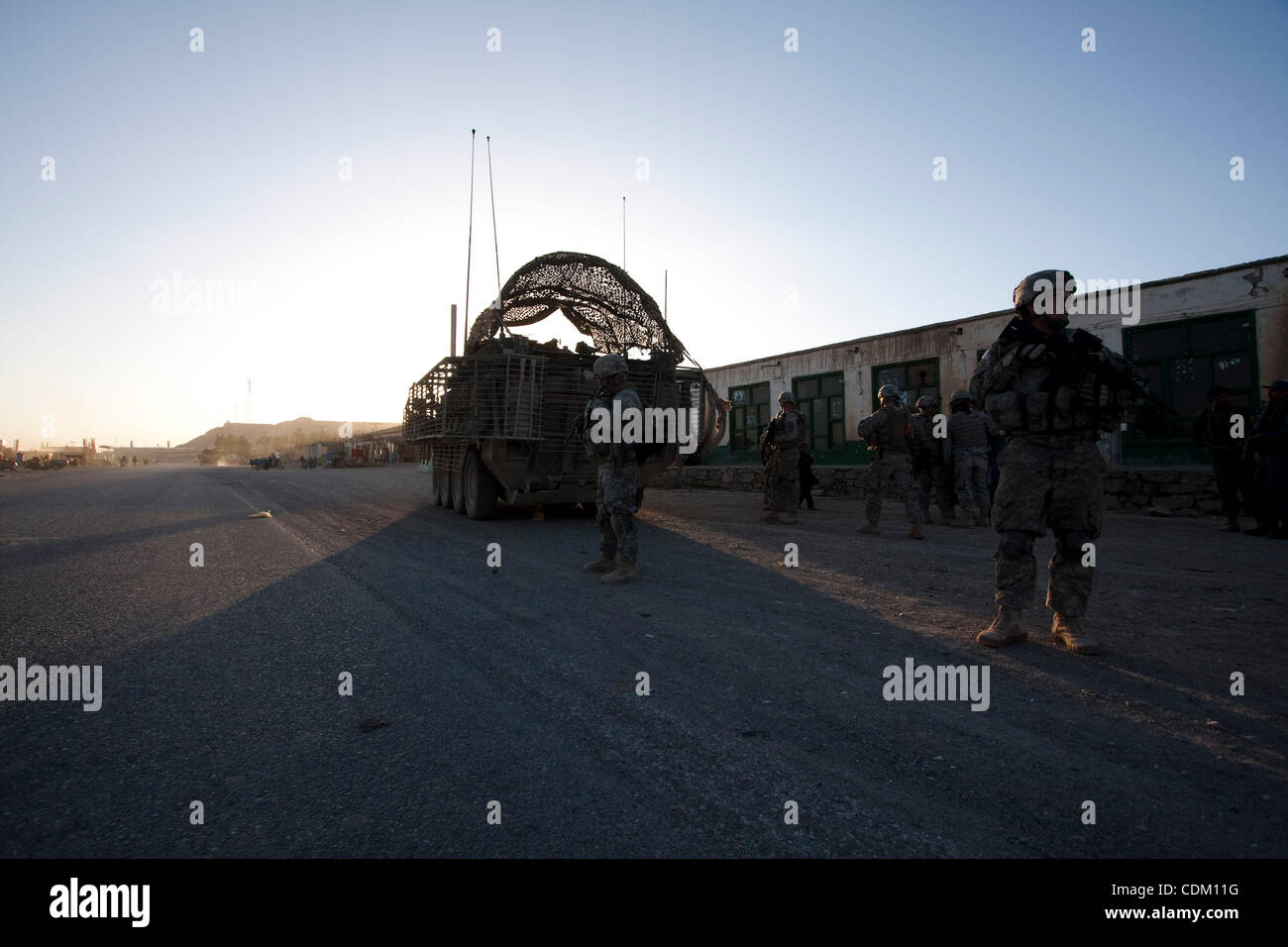 Mar 29, 2011 - Qalat, Zabul province, Afghanistan - Members of MGS Platoon, Fox Company of 2nd Squadron, 2nd Stryker Cavalry Regiment secure the area as members of the Afghan National Police Headquarters Reserve Kandak conduct a raid on a target in the City of Qalat, Zabul province, Afghanistan. The Stock Photo