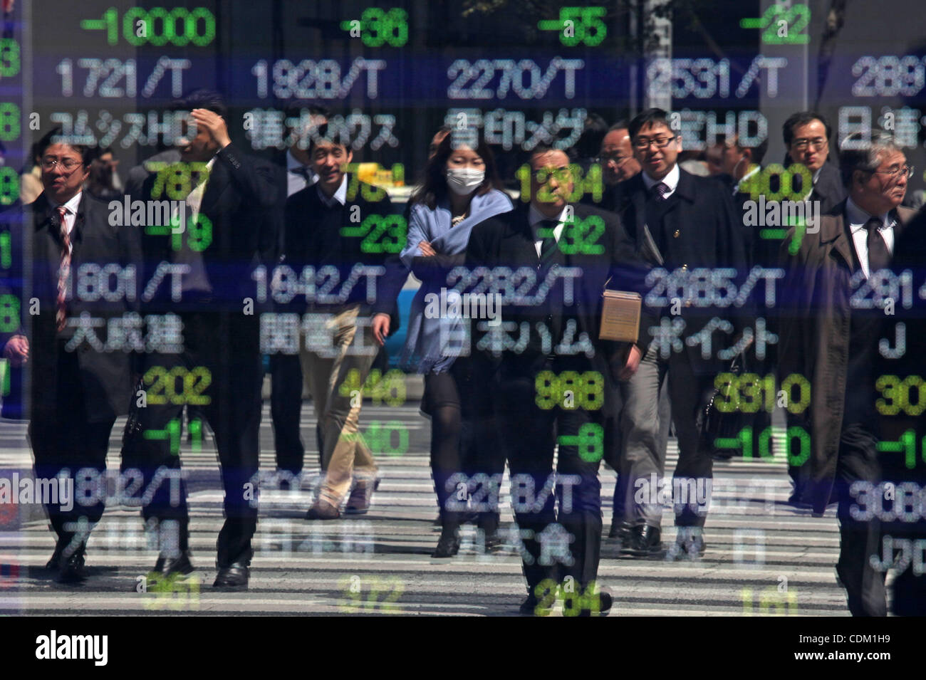 Mar. 29, 2011 - Tokyo, Japan - Japanese businessmen are reflected the board indicating stock prices in downtown Tokyo. Due to the Fukushima nuclear accident, the share price of the Tokyo Electric Power Company dropped 566 yen, its lowest since April 1964. (Credit Image: © Koichi Kamoshida/Jana Press Stock Photo