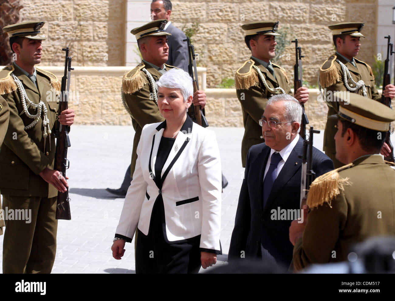 Palestinian Prime Minister Salam Fayyad  reviews honor guards with the Croatian counterpart Jadranka Kosor upon her arrival to the West Bank city of Ramallah, on March 31,2011. Photo by Issam Rimawi Stock Photo