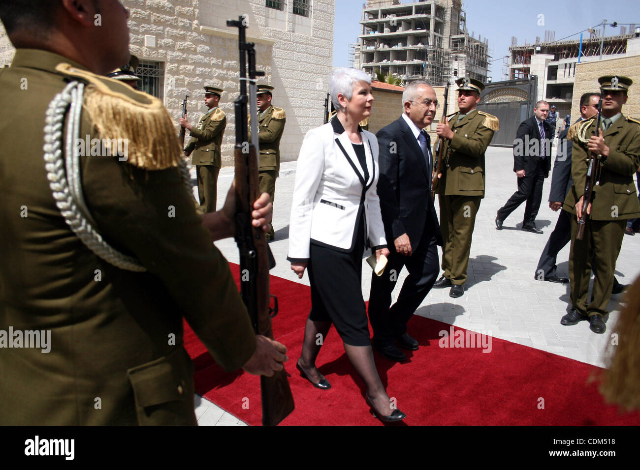 Palestinian Prime Minister Salam Fayyad  reviews honor guards with the Croatian counterpart Jadranka Kosor upon her arrival to the West Bank city of Ramallah, on March 31,2011. Photo by Issam Rimawi Stock Photo