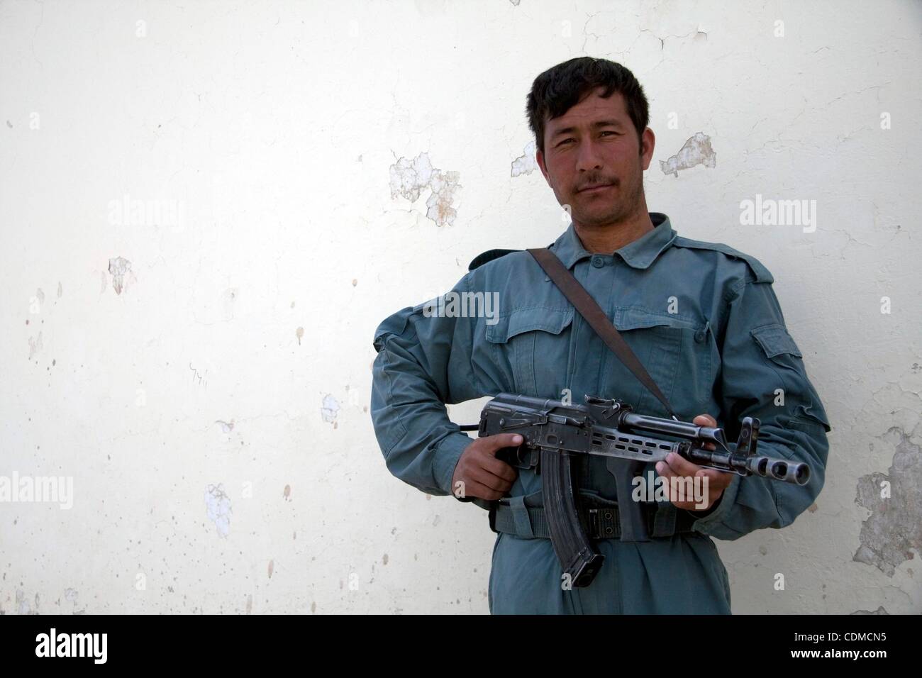 Apr 05, 2011 - Kandahar, Afghanistan - A policeman with the Afghan National Police from the northern province of Kunduz outside the Dand district Center. While the local police force starts to get recruits fom the area, this policeman only speaks Dari and cannot communicate with the local population Stock Photo