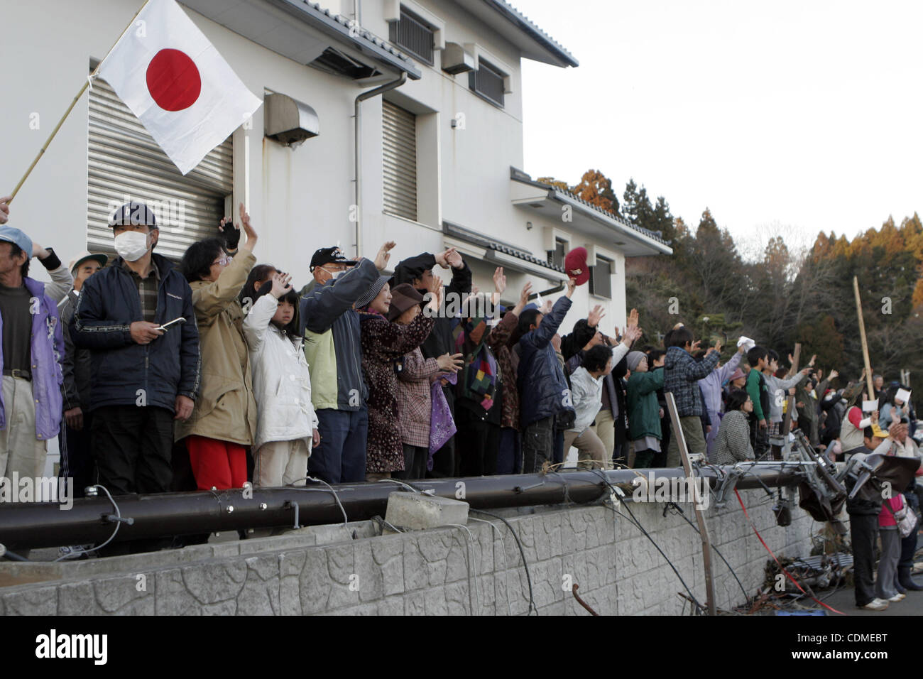 Apr. 6, 2011 - Miyagi, Japan - OSHIMA ISLAND, Miyagi, Japan - About 200 residents wave goodbye to Marines and Sailors of the 31st Marine Expeditionary Unit, as they board a U.S. Navy landing craft utility, April 6.  The Marines and Sailors spent about six days cleaning up debris on parts of the isla Stock Photo