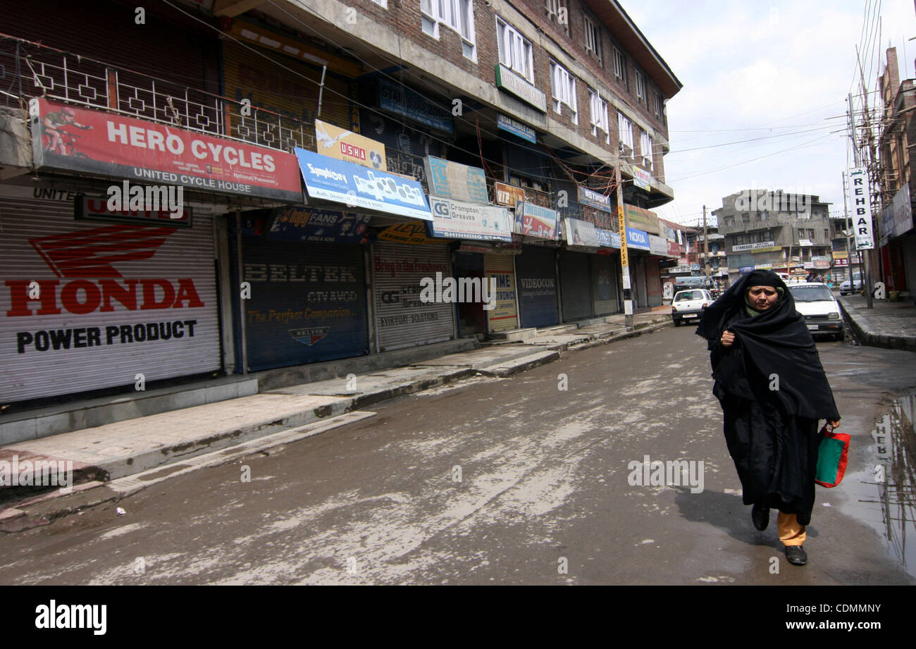 A kashmiri muslim women walks during strike aganist the attempt to divide the state along communal in srinagar, the summer capital of indian kashmir on 11/4/2011, Kashmir remained shut for the third consecutive day today following a strike call given by hard line faction of Hurriyat Conference over  Stock Photo