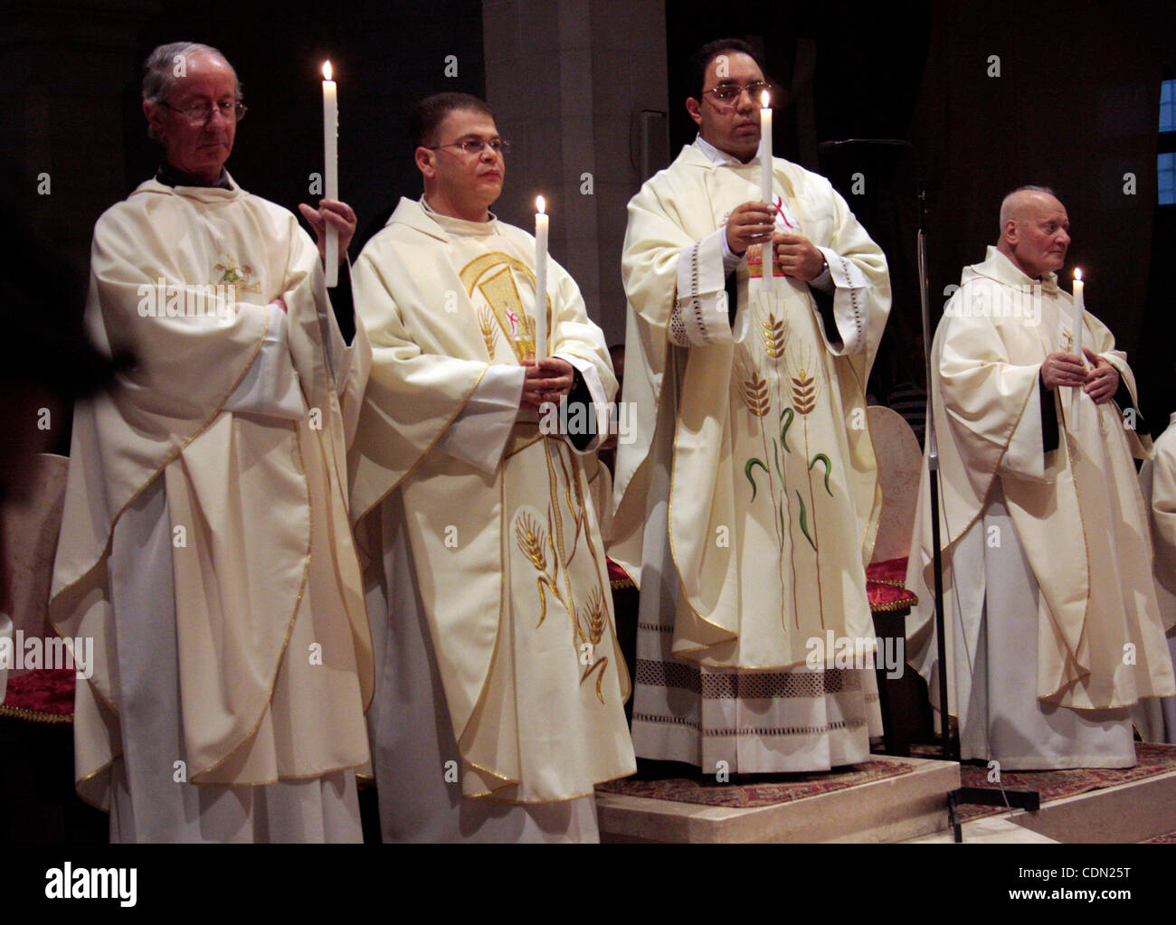 A Catholic priest lights a Paschal candle inside the Church of the ...