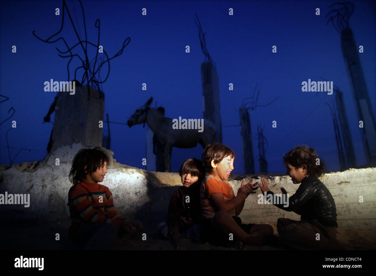 Palestinian children play outside a tent which was erected outside ...