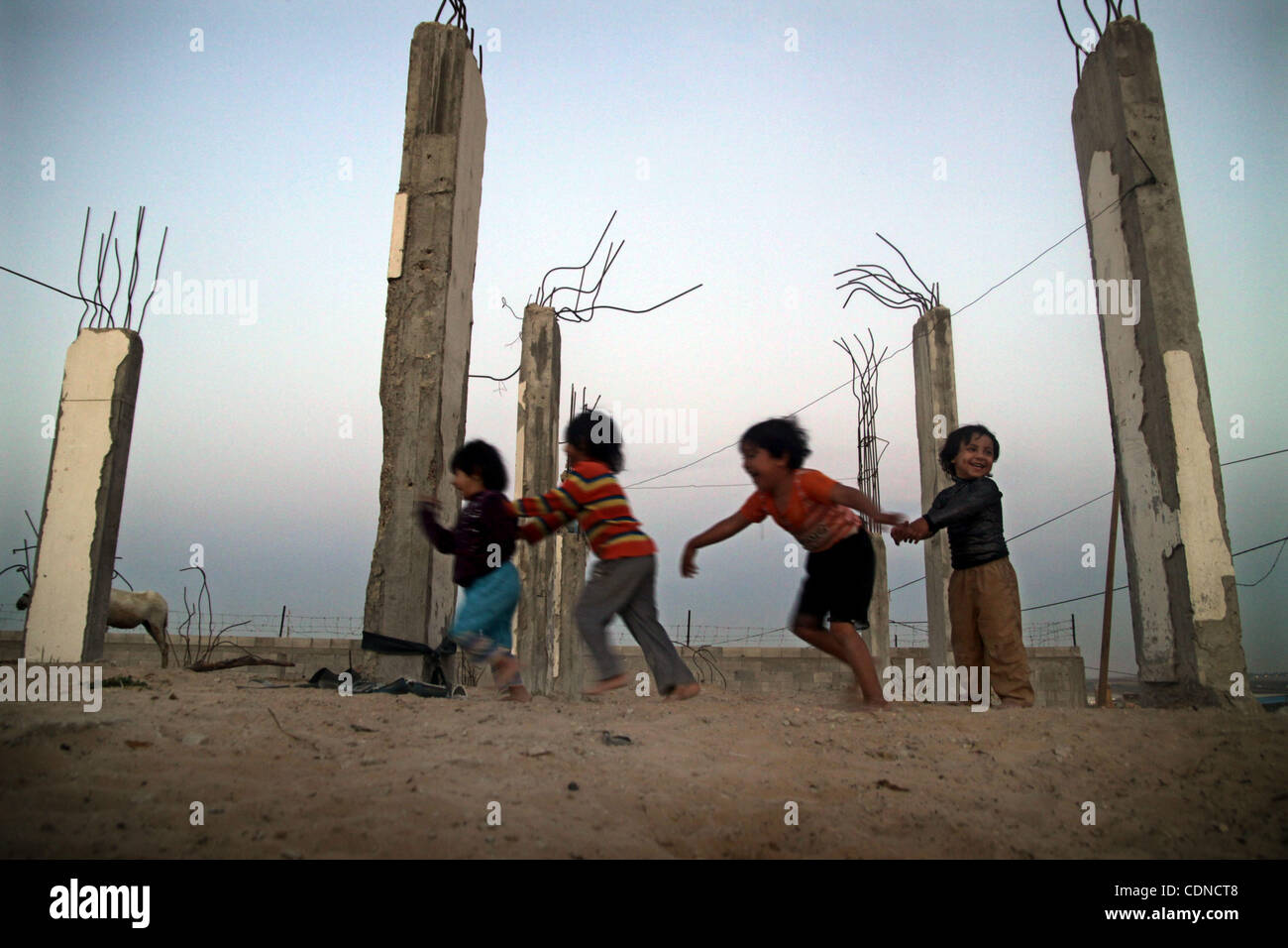 Palestinian children play outside a tent which was erected outside ...