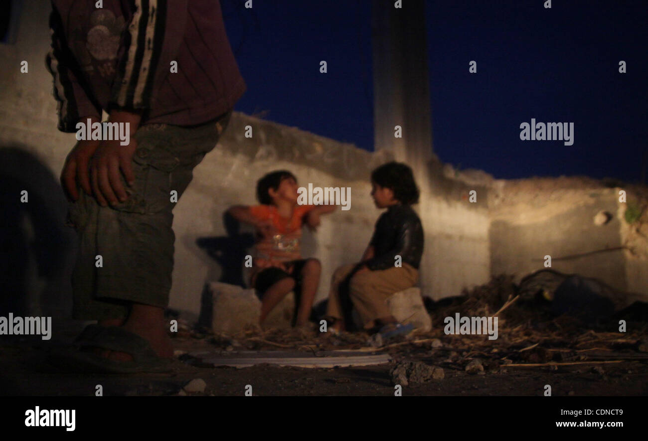 Palestinian children play outside a tent which was erected outside ...