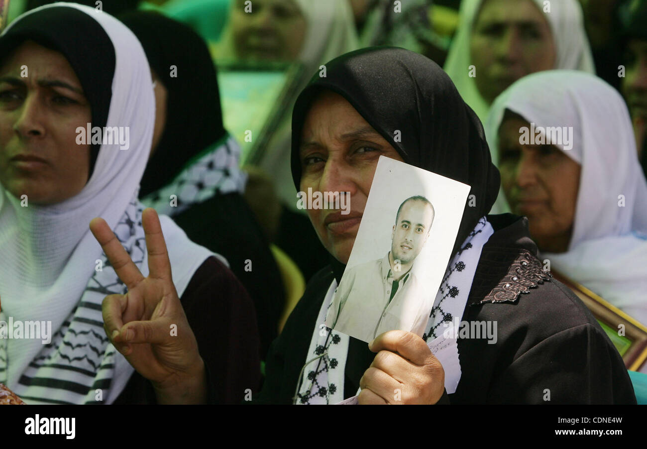 Palestinians women hold pictures of jailed relatives during a protest calling for their release from Israeli prisons near Erez crossing between Israel and the northern Gaza Strip on May 28, 2011. Photo by Yasser Fathi Stock Photo
