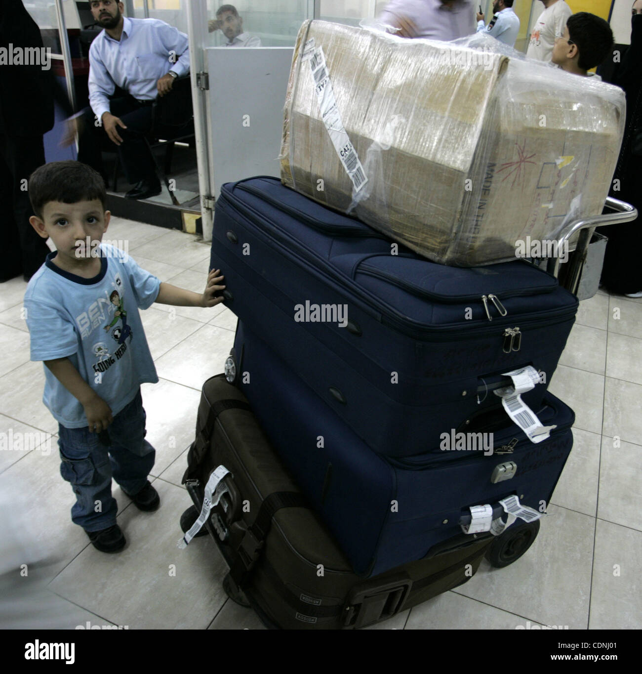 A Palestinian boy with his family during loading their luggage coming from Egypt through the Rafah border crossing in the southern Gaza Strip on on June 13, 2011. Photo by Abed Rahim Khatib Stock Photo